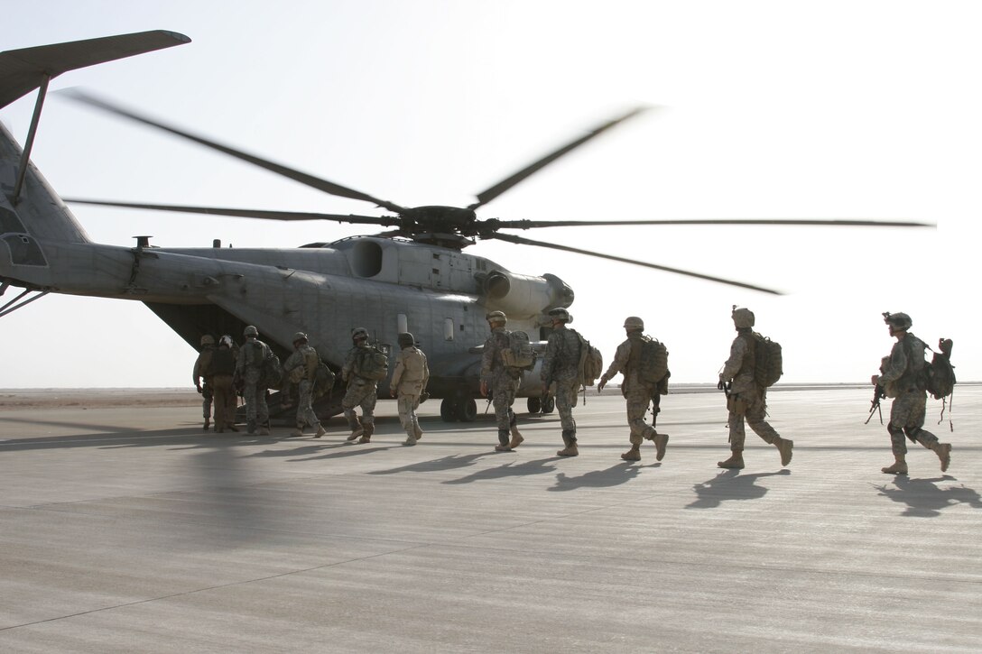 Soldiers from 3rd Battalion, 504th Parachute Infantry Regiment, 82nd Airborne Division, load into the bay of a CH-53E Super Stallion. The soldiers were flown to a forward location in Al Anbar province by the Warhorses of Marine Heavy Helicopter Squadron 465 from Al Asad, Iraq, Sept. 21.
