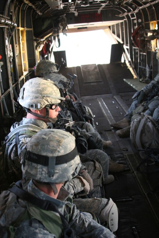 Soldiers from 3rd Battalion, 504th Parachute Infantry Regiment, 82nd Airborne Division, sit in the bay of a CH-53E Super Stallion. The soldiers were flown to a forward location in Al Anbar province by the Warhorses of Marine Heavy Helicopter Squadron 465 from Al Asad, Iraq, Sept. 21.