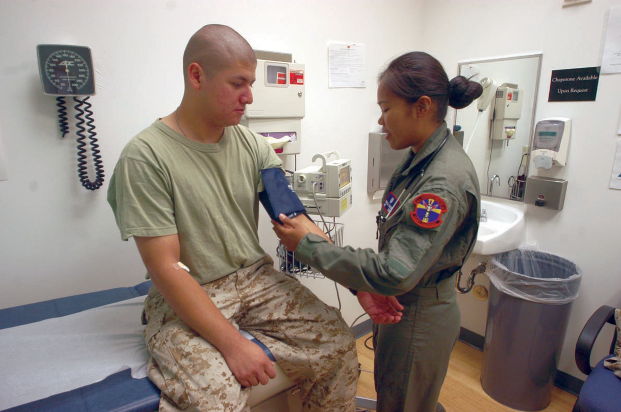 EDWARDS AIR FORCE BASE, Calif. -- Airman Shella Mae Valdez checks Marine Cpl. Dario Leiva's blood pressure.  Medical personnel here examined 40 Marines returning from a deployment to ensure they met their medical readiness requirements.  Airman Valdez is an aeromedical technician with the 95th Aerospace Medical Squadron.  Corporal Leiva is a logistics clerk assigned to the Marine Aircraft Group 46, Detachment Bravo.  (U.S. Air Force photo by Senior Airman Jet Fabara)