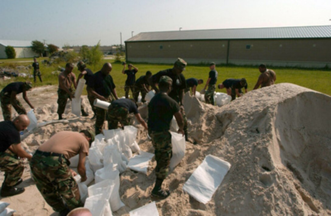 U.S. Air Force airmen with the 147th Fighter Wing fill sandbags to protect base buildings from potential flooding from approaching Hurricane Rita at Ellington Field, Houston, Texas, on Sept. 21, 2005. 