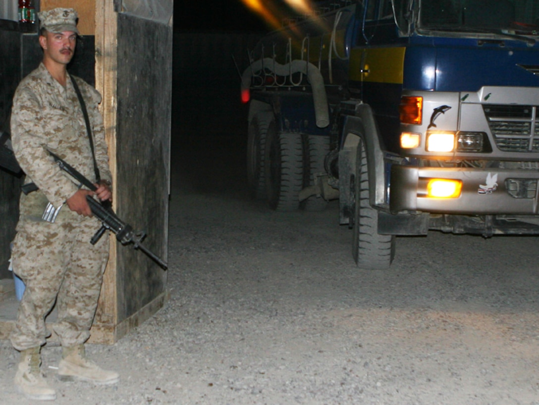 CAMP FALLUJAH, Iraq -When the majority of people aboard the camp are preparing for bed, there are Marines scattered throughout walking their post. One of these protectors, Lance Cpl. Glade L. Wallen, 29, a food service specialist assigned to Food Service Section, II Marine Expeditionary Force, Headquarters Group (FWD),stands watch providing security against those who might do harm to the members of the camp. Wallen, a trained food service specialist, is a 1995 graduate of Timpview High School in Provo, Utah. (Official U.S. Marine Corps photo by Cpl. Ruben D. Maestre)
