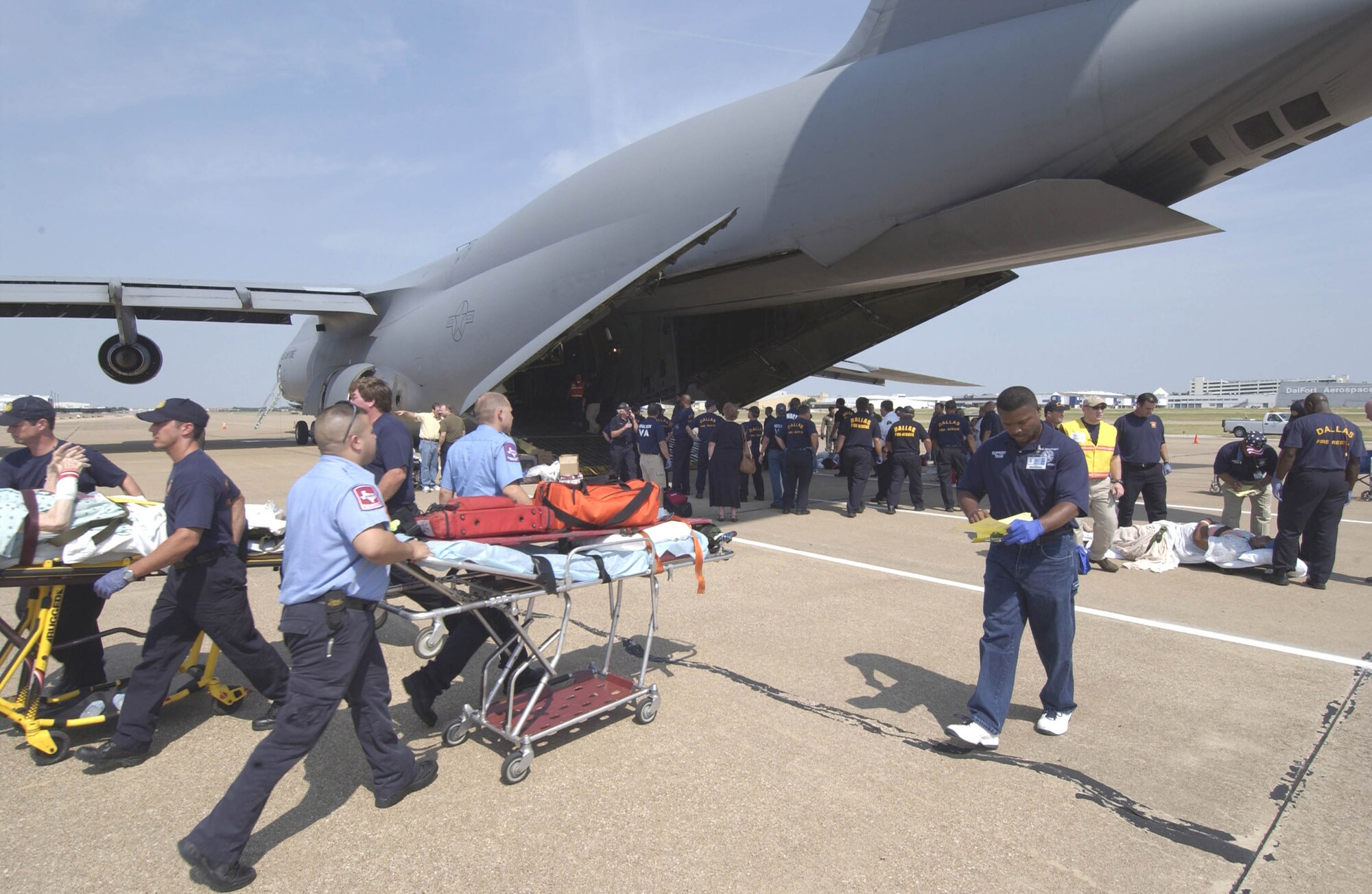 DALLAS -- Hospital patients from Beaumont, Texas, are taken off a C-5 Galaxy Sept. 23 en route to one of the many medical facilities set up to care for evacuees from the path of Hurricane Rita.  The aircraft is from the from the 21st Airlift Squadron, Travis Air Force Base, Calif.  The U.S. Air Force is contributing to the Hurricane Rita humanitarian assistance operations being led by the Federal Emergency Management Agency in conjunction with the Department of Defense. (U.S. Air Force photo by Tech. Sgt. Jennifer C. Wallis)