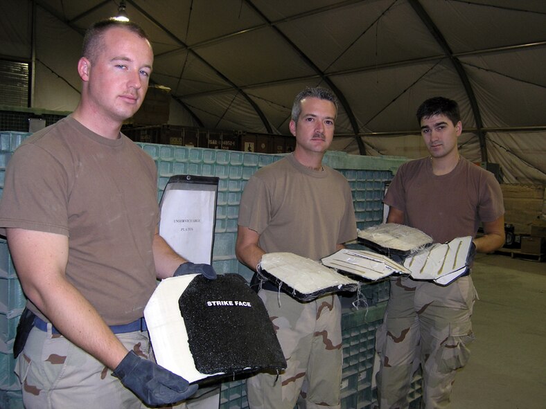 ALI BASE, Iraq -- (From left) Senior Airman Josh Warren, Master Sgt. Steve Strange and Senior Airman Caslon Smith hold damaged plates that were removed from body armor vests.  Much of the armor is unusable because it was mishandled.  The Airmen are assigned to the 407th Expeditionary Logistics Readiness Squadron here.  (U.S. Air Force photo by Tech. Sgt. Paul Dean)