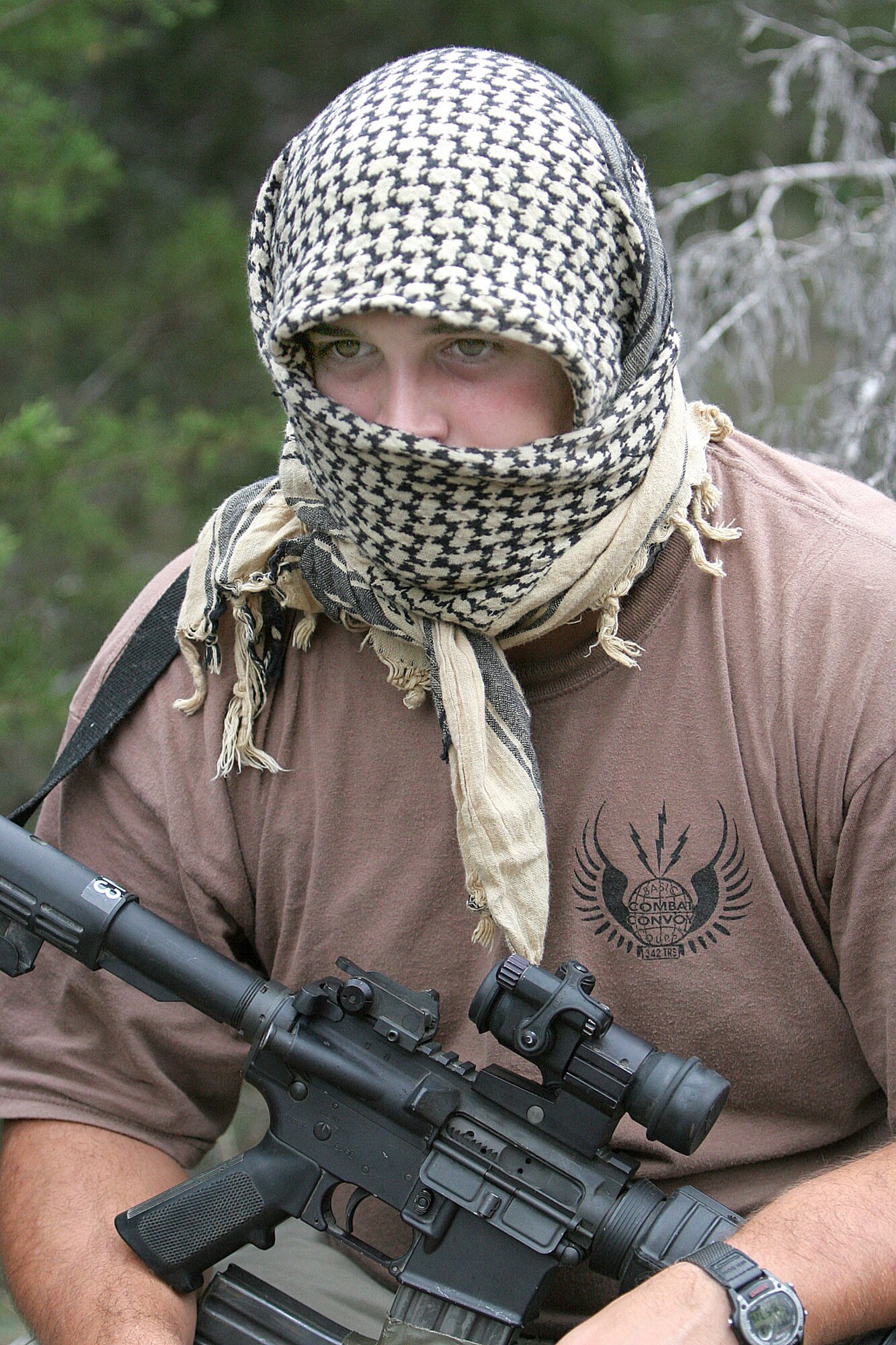 CAMP BULLIS, Texas -- Staff Sgt. Kendall Beasley plays the part of an insurgent as he waits to "ambush" a convoy during the Basic Combat Convoy Course here.  He is a course instructor and an intelligence specialist who served in Iraq for seven months.  (U.S. Air Force photo by Robbin Cresswell)