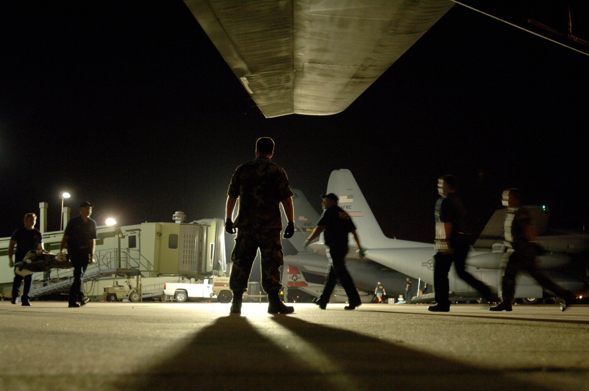 BEAUMONT, Texas -- Members of the 433rd Aeromedical Evacuation Squadron worked through the night to transport patients to aircraft waiting to airlift them out of the path of Hurricane Rita.  The Reserve unit, from Lackland Air Force Base, Texas, also airlifted two mobile staging facilities to Beaumont and to nearby Port Arthur, Texas.  In less than a day and a half, they had helped evacuate more than 6,800 people -- 1,306 of them special-needs patients -- to cities in Texas and elsewhere.  (U.S. Air Force photo by Master Sgt. Lance Cheung)