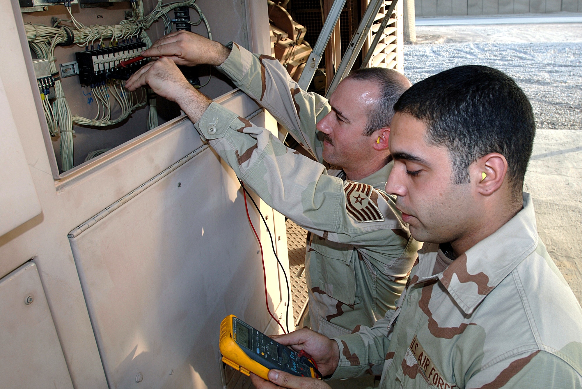 ALI BASE, Iraq -- Tech. Sgt. Steven Slater (left) and Senior Airman Jamie Lugo, maintain a generator here. They are assigned to the 407th Expeditionary Group Civil Engineer Squadron. (U.S. Air Force photo by Master Sgt. Maurice Hessel)