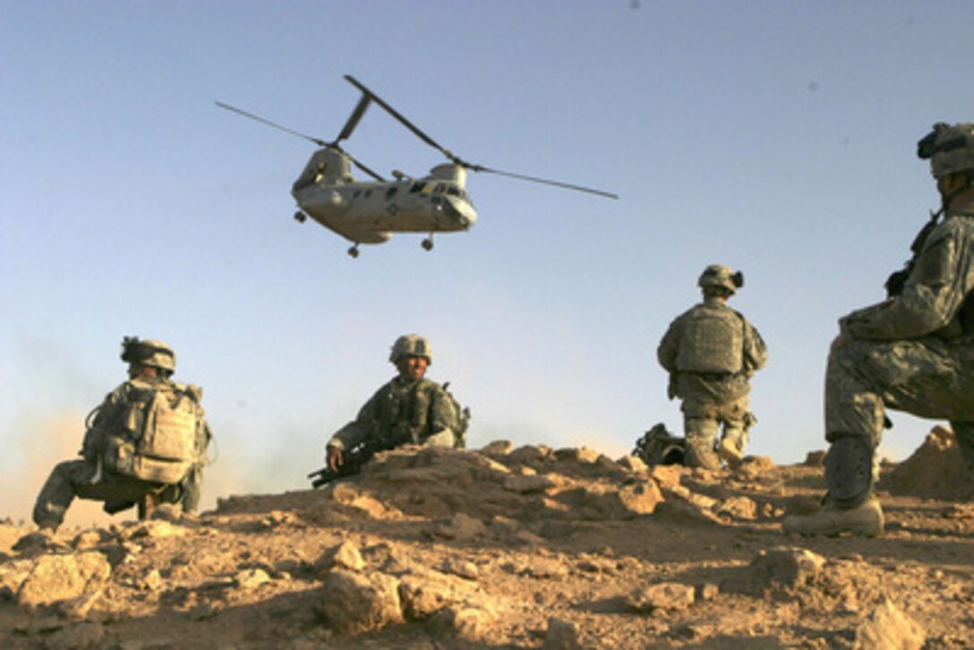 U.S. Army soldiers set up a security perimeter after landing in the desert at the start of an operation in Baghdaddi, Iraq, on Sept. 21, 2005. The soldiers are conducting counterinsurgency operations with Iraqi security forces to create a secure environment. The soldiers are assigned to Charlie Company, 3rd Battalion, 504th Parachute Infantry Regiment. 