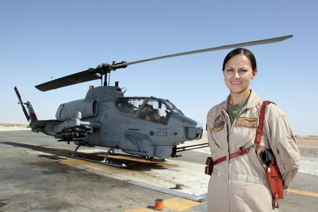 AL ASAD, Iraq ? Captain Jessica M. Moore, an AH-1 Cobra pilot with Marine Light Attack Helicopter Squadron 167, poses in front of one of the aircraft she pilots.  Moore was recently named one of the 2005 Military Women of Merit by the North County Times, a large San Diego area newspaper.