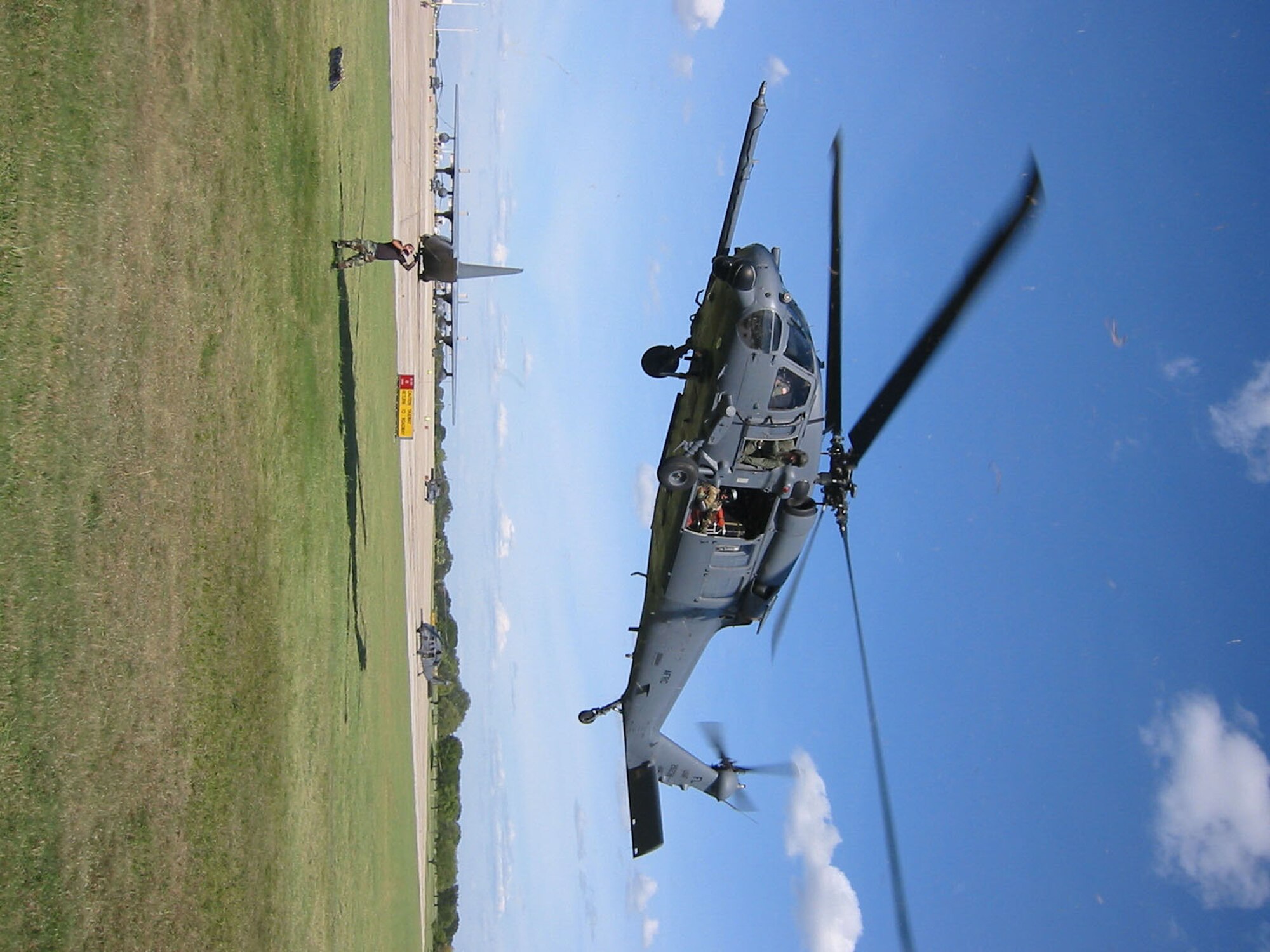 RANDOLPH AIR FORCE BASE, Texas -- Senior Airman Ronald Arroyo watches an HH-60 helicopter descend after an operational winch check Saturday.  Airman Arroyo is a crew chief assigned to the Air Force Reserve's 920th Rescue Wing, Patrick Air Force Base, Fla.  (U.S. Air Force photo by Tech. Sgt. Jason Tudor)