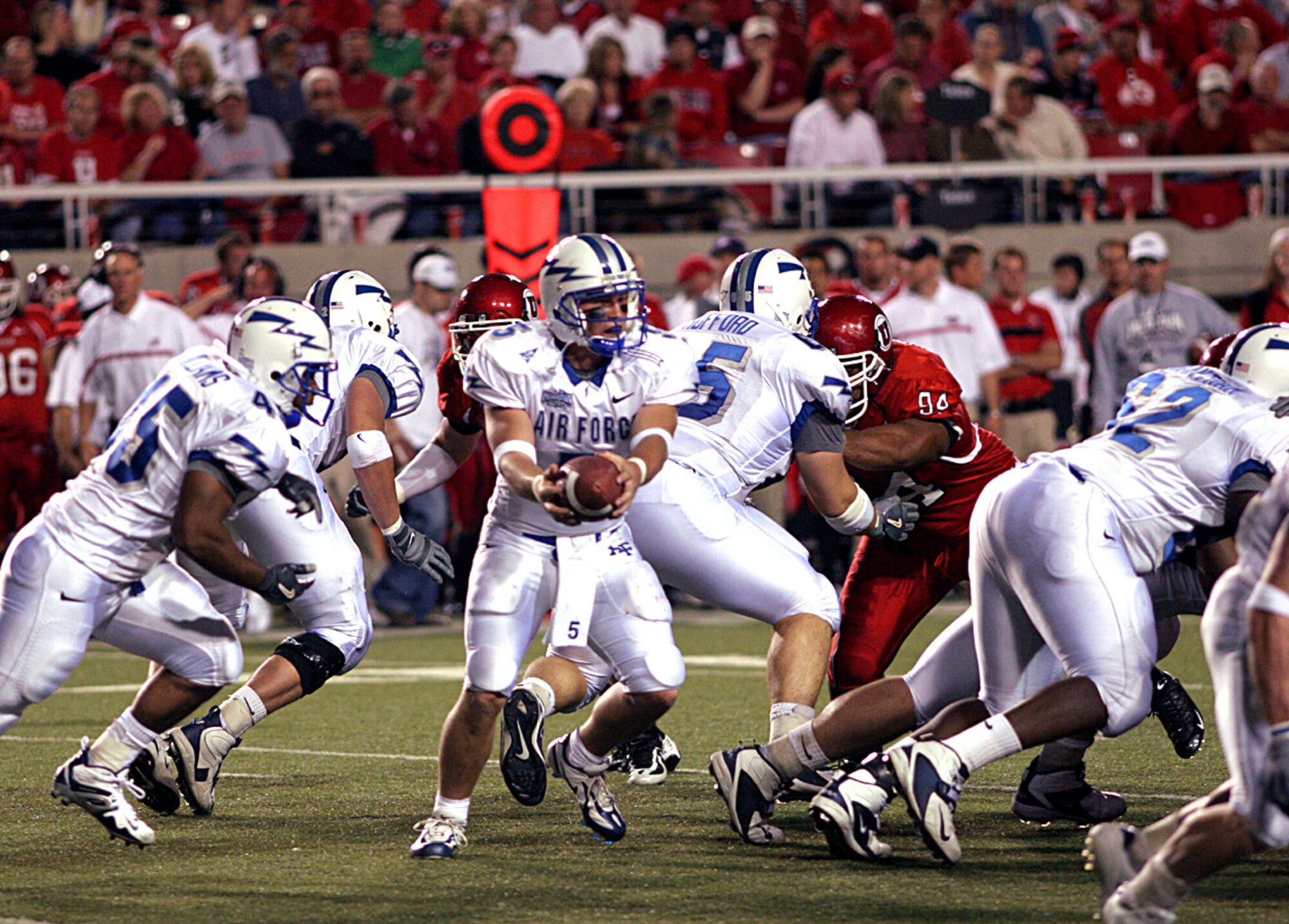SALT LAKE CITY --  Air Force quarterback Shaun Carney, 5, readies a handoff to fullback Ryan Williams, 45, as the Falcon offensive line clears the way. (U.S. Air Force photo by Ken Carter) 
