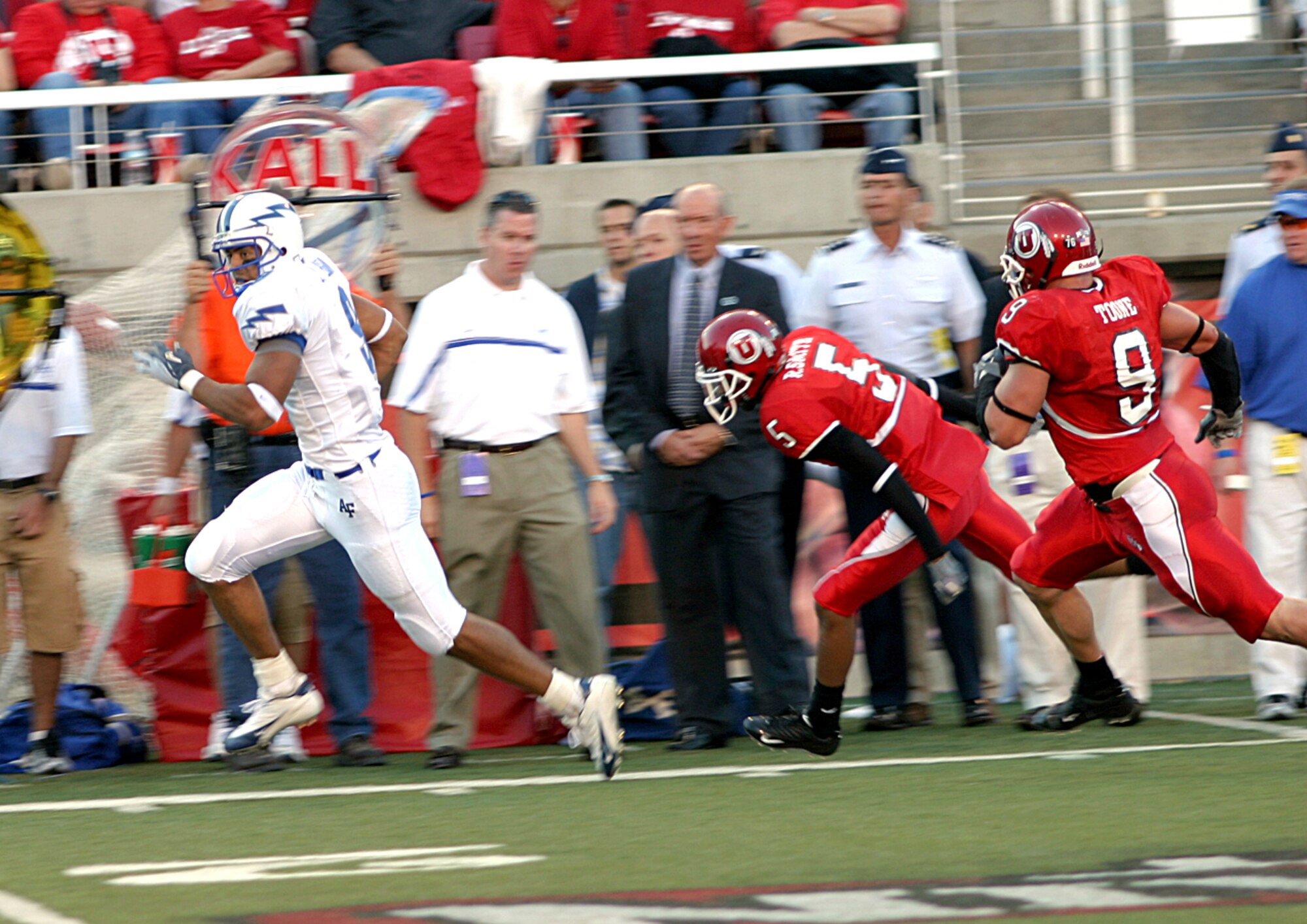 SALT LAKE CITY -- Falcon wide receiver Jason Brown streaks down the Air Force sideline with a pass as University of Utah cornerback Ryan Smith, 5, and rover Spencer Toone are in hot pursuit. (U.S. Air Force photo by Ken Carter)
