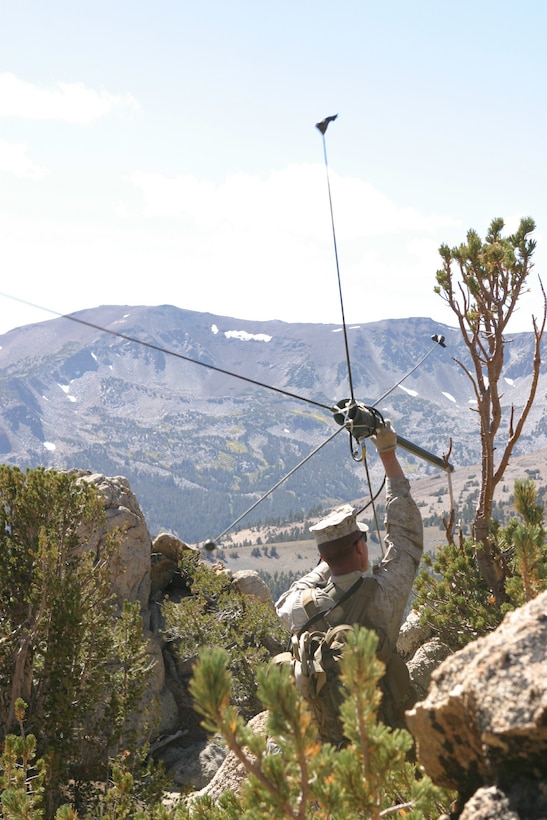 Capt. Thomas Kisch, Company Commander for 1/3's Alpha Company and a native of St. Louis Park, Minn., sets up a OE254 communications system near the summit of Lost Cannon Mountain near the Marine Corps Mountain Warfare Training Center in Bridgeport, Calif.