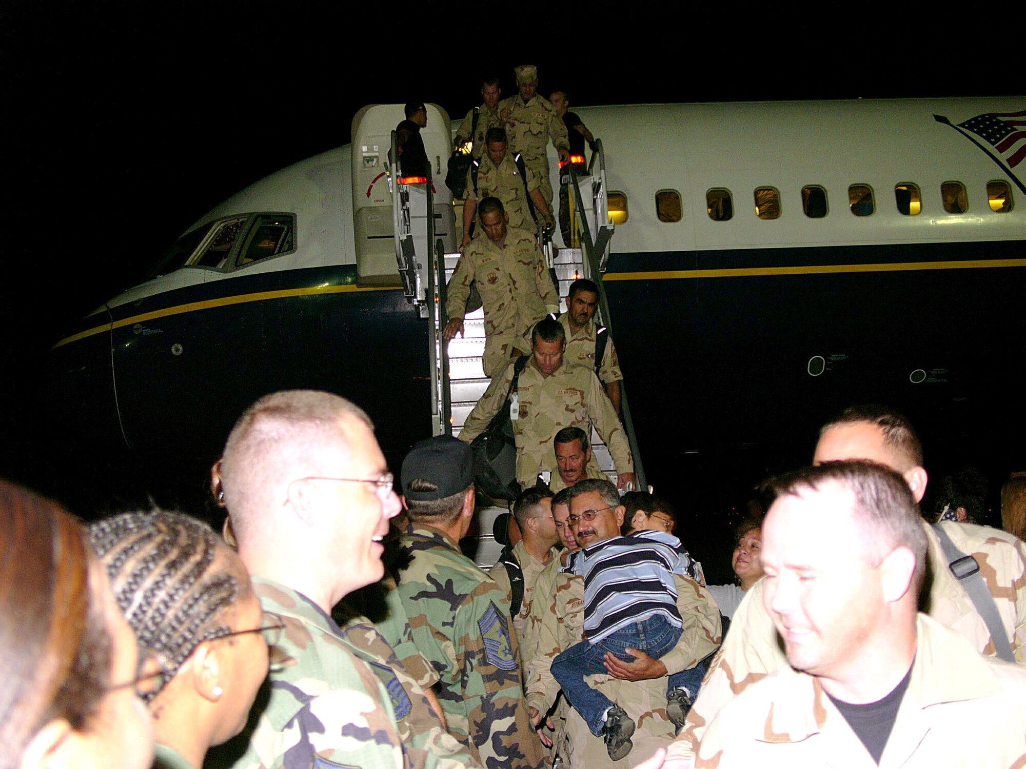 ELLINGTON FIELD, Texas -- Airmen with the 147th Fighter Wing return home from Balad Air Base, Iraq on Sept. 25.  Many of the Airmen's families were there to meet them despite being evacuated for Hurricane Rita.  (U.S. Air Force photo by Master Sgt. Bob Blauser)
