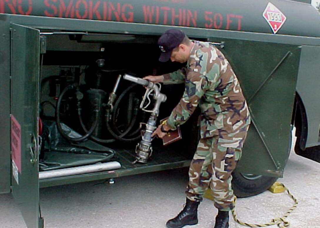 ELLINGTON FIELD, Texas -- Master Sgt. Lynn Bailey adjusts a custom-built fuel truck nozzle here.  He and Staff Sgt. Vic Taylor created the nozzle after two Texas Army National Guard fuel trucks were unable to refuel evacuation support buses in Beaumont, Texas, Sept. 23.  Those fuel nozzles were not compatible with the buses.  Sergeants Bailey and Taylor are with the 147th Fighter Wing fuels shop.  (U.S. Air Force photo by Master Sgt. Marcus Falleaf)