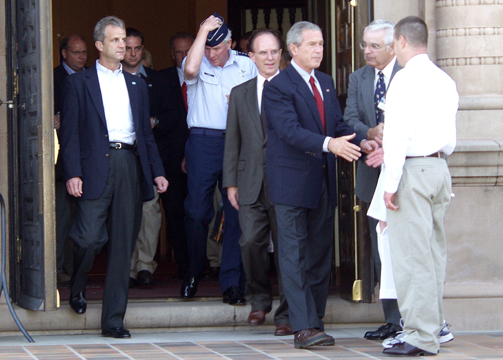 RANDOLPH AIR FORCE BASE, Texas -- President George W. Bush greets a member of the Randolph Chapel congregation here following morning services Sept. 25. The president spent the night at the San Antonio base where he received updates about the military's response to Hurricane Rita. (U.S. Air Force photo by Michael Briggs)