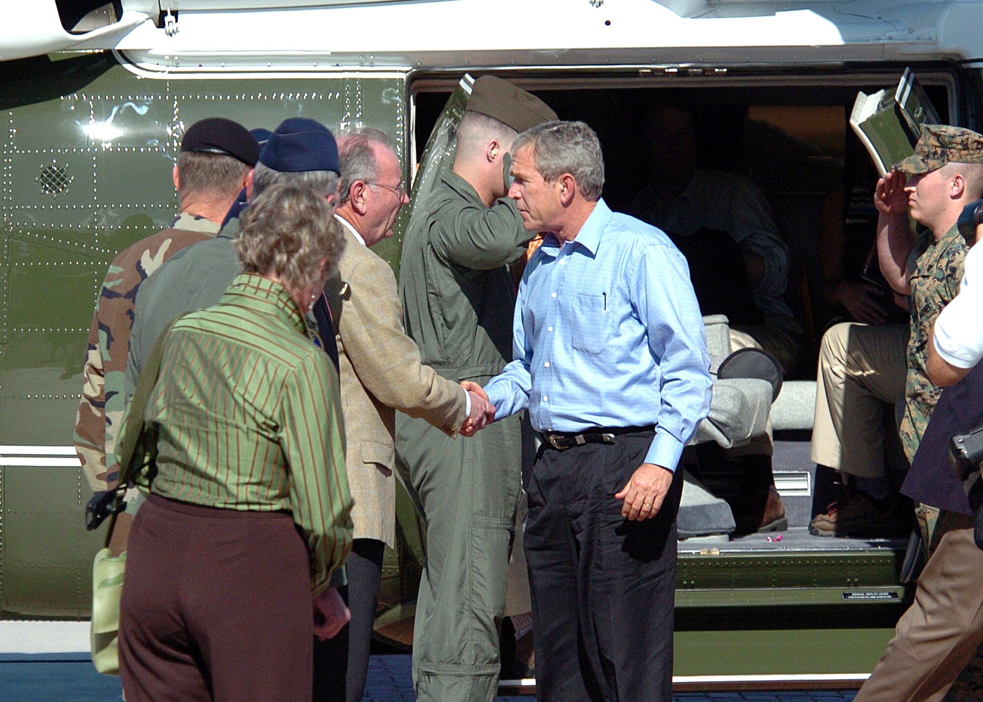 RANDOLPH AIR FORCE BASE, Texas -- President George W. Bush is greeted by San Antonio Mayor Phil Hardberger and other civilian and military representatives Sept. 24 upon his arrival here in Marine One. The president visited Randolph to receive an update about the military's role in Hurricane Rita relief operations. (U.S. Air Force photo by Steve White)