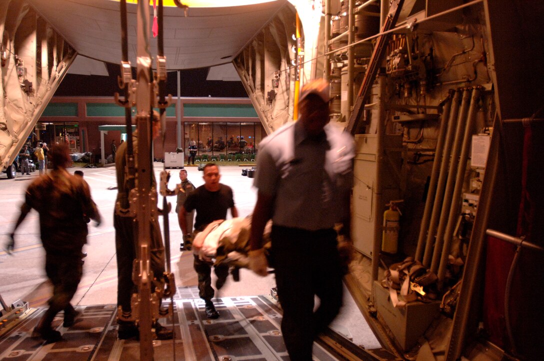 BEAUMONT, Texas -- A patient is carried aboard a C-141 Starlifter here Sept. 22, during the evacuation of residents before the arrival of Hurricane Rita. Airmen from the 433rd Aeromedical Evacuation Squadron at Lackland Air Force Base, Texas, and the 183rd AES from the Mississippi Air National Guard conducted the evacuation. The evacuees were from regional hospitals, nursing homes and the local community.  Air Force, Coast Guard and Navy aircraft airlifted nearly 2,000 patients and residents. (U.S. Air Force photo by Master Sgt. Lance Cheung)