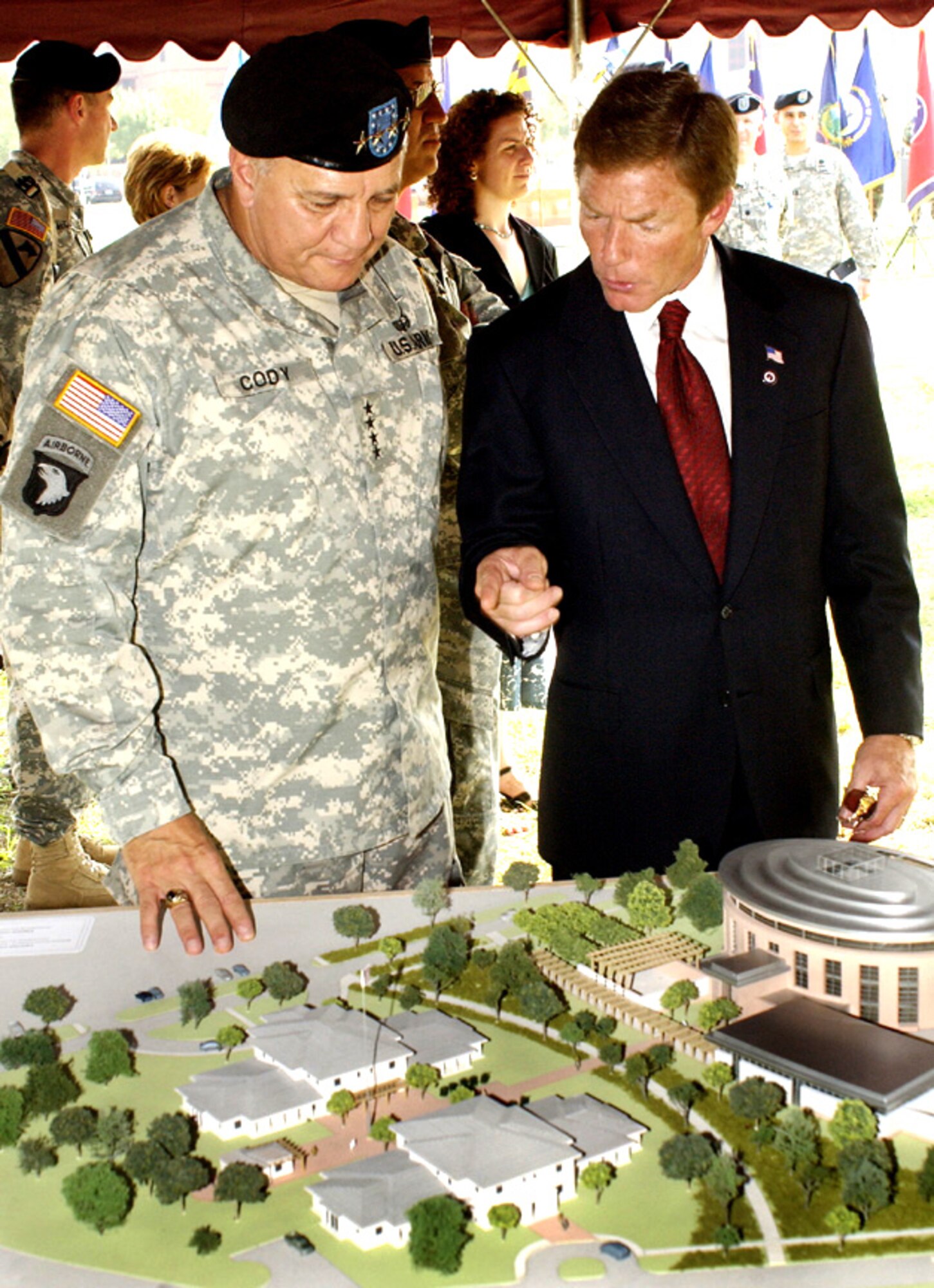 FORT SAM HOUSTON, Texas -- Ken Fisher, chairman of the Fisher House Foundation, shows a model of the National Armed Forces Physical and Rehabilitation Center to Gen. Richard Cody, Army vice chief of staff, at the Sept. 22 groundbreaking for the facility that will be built near Brooke Army Medical Center here.  (U.S. Army photo by Darren Reehl)       