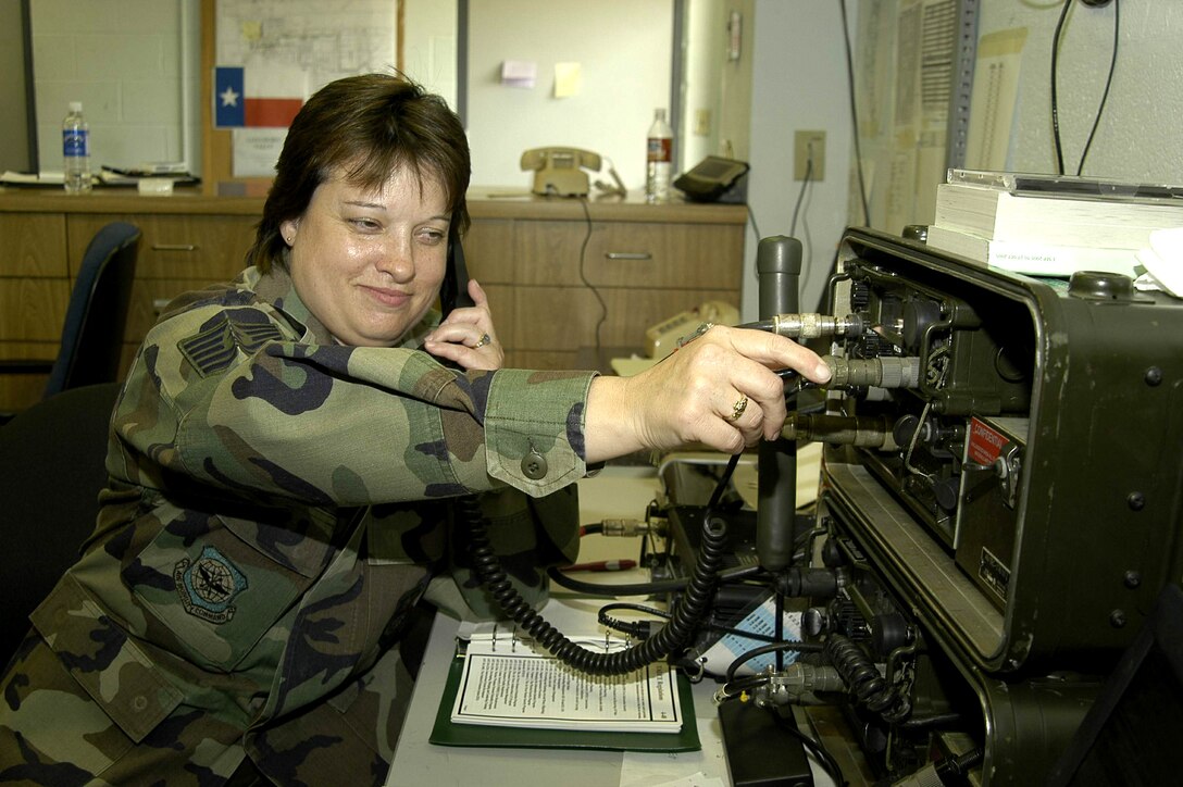 ELLINGTON FIELD, Texas -- Tech. Sgt. Michelle Kiral takes a radio call from an inbound aircraft supporting Hurricane Rita relief operations here. She is with the 136th Tanker Airlift Control Element from Fort Worth, Texas. The unit was wrapping up operations in Gulfport, Miss., when it was diverted here Sept. 24. (U.S. Air Force photo by Rich Lamance)
