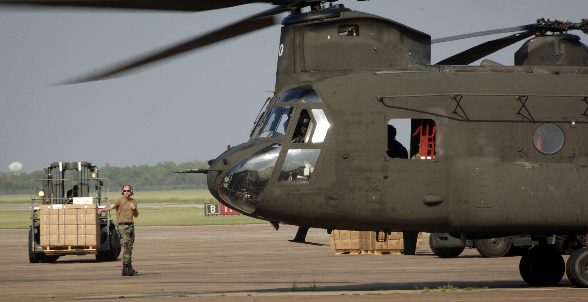 ELLINGTON FIELD, Texas - Airmen from the 136th Tanker Airlift Control Element and the 136th Aerial Port Squadron assist with the loading of supplies onto an Army CH-47 Chinook here Sept. 25 in support of the Hurricane Rita relief effort. The Airmen are from Naval Air Station-Joint Reserve Base Fort Worth, Texas. (U.S. Air Force photo by Master Sgt. Lance Cheung)