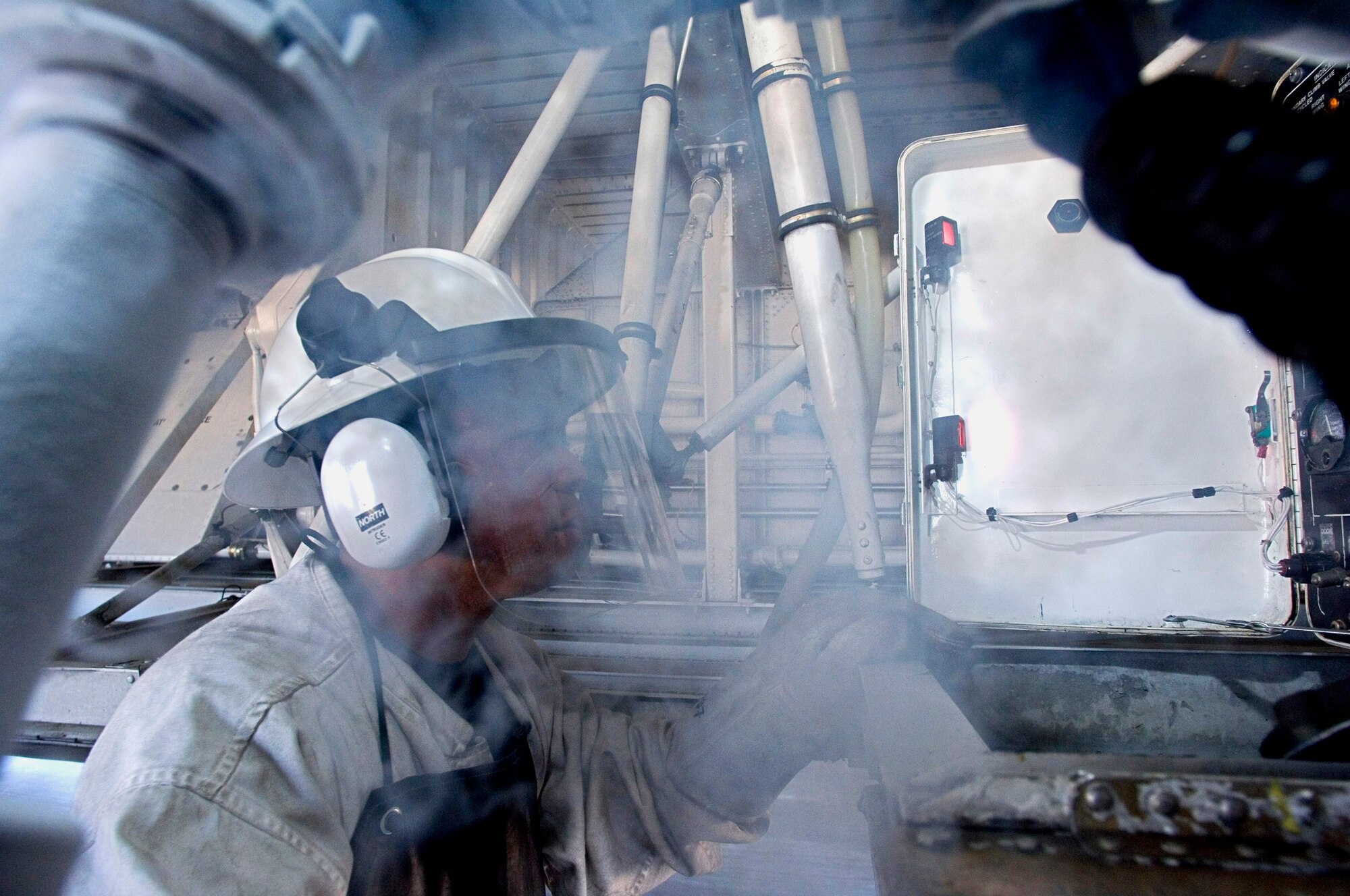 MORON AIR BASE, Spain -- Tech. Sgt. Ranill Hirang of the 4th Expeditionary Air Mobility Squadron monitors the gauges as liquid nitrogen is pumped into a C-5 Galaxy here. Sergeant Hirang is deployed from Travis Air Force Base, Calif., where he is assigned to the 60th Equipment Maintenance Squadron. (U.S. Air Force photo by Master Sgt. John E. Lasky)
