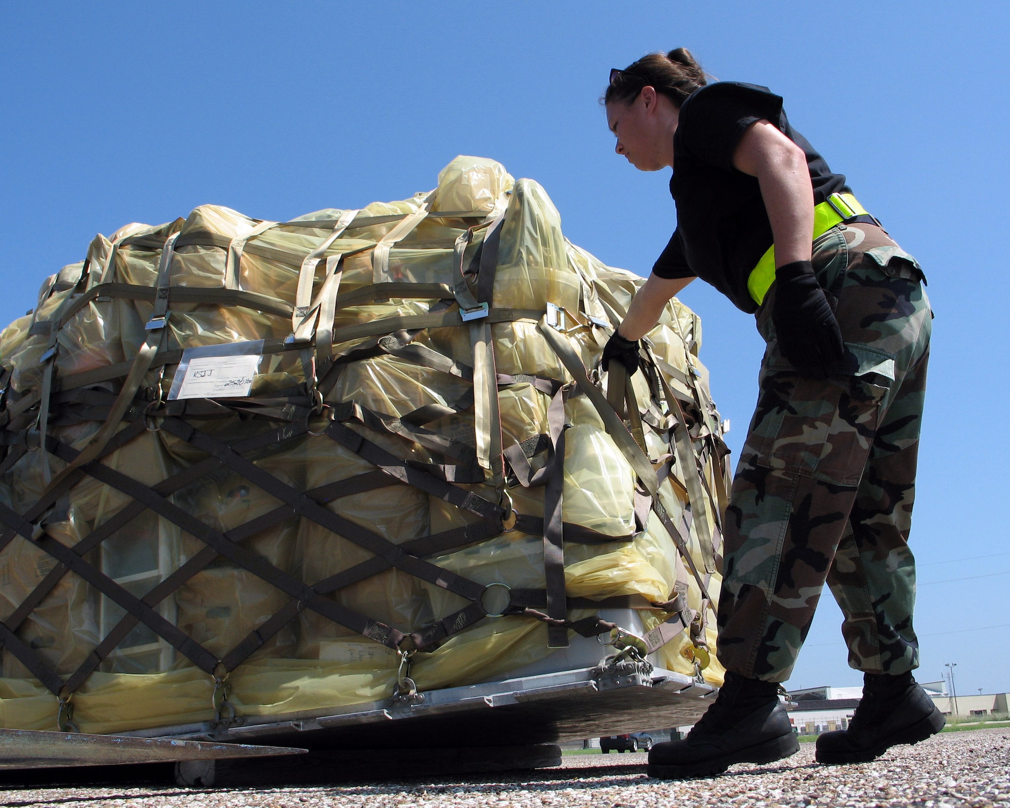 ELLINGTON FIELD, Texas -- Staff Sgt. Colleen Jenkins guides a pallet of relief supplies into place for use in the Hurricane Rita relief effort here. The supplies, moved Sept. 26, were donated by the Missouri Air National Guard. Sergeant Jenkins is an air transportation journeyman with the 136th Aerial Port Squadron at Naval Air Station-Joint Reserve Base Fort Worth, Texas. (U.S. Air Force photo by Master Sgt. Lee Roberts)