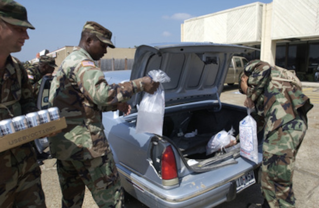 U.S. Army soldiers of Bravo Company, 449th Aviation Support Battalion, distribute cases of meals, ready to eat, ice and bottled water to the residents of Orange, Texas, in support of Hurricane Rita relief efforts on Sept. 26, 2005. Department of Defense units are mobilized as part of Joint Task Force Rita to support the Federal Emergency Management Agency's disaster-relief efforts in the Gulf Coast areas devastated by Hurricane Rita. 