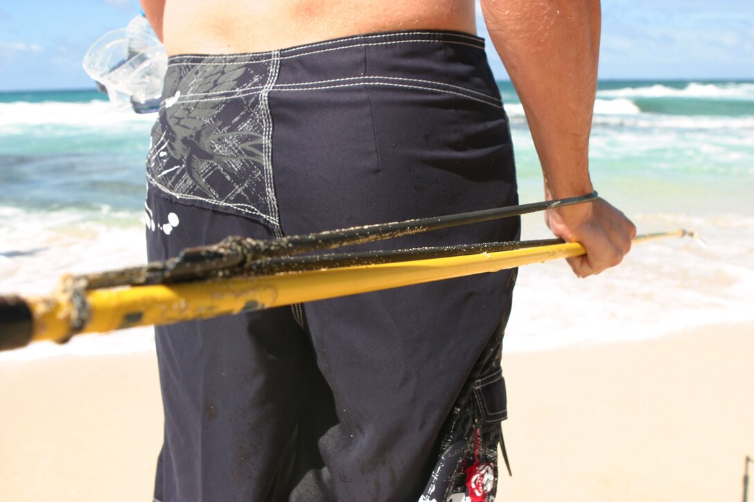 A Hawaiian sling spear is one of the most common spears used when spear fishing.  It works by pulling back on a rubber band and releasing the pole, the spear is then projected into the direction it is pointed at.