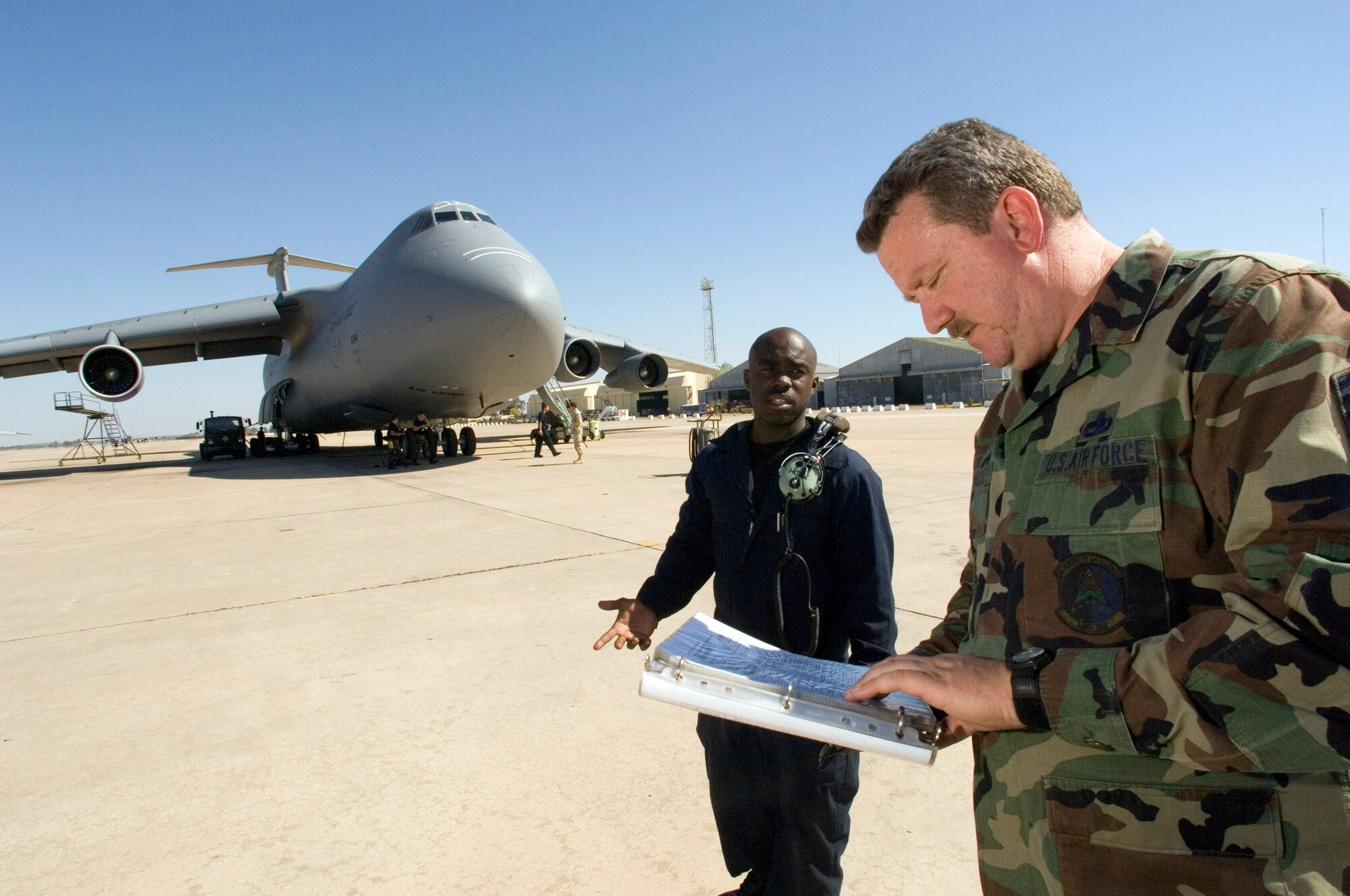 MORON AIR BASE, Spain -- Production superintendent Senior Master Sgt. Bill Morrissey (right) and hydraulics specialist Staff Sgt. Dante Davis discuss a repair needed on a C-5 Galaxy aircraft. Both Airmen are on temporary duty with the 4th Expeditionary Air Mobility Squadron to at this base in southern Spain. Sergeant Morrissey is a reservist from the 349th Component Repair Squadron and Sergeant Davis is with the 60 th Aircraft Maintenance Squadron, both at Travis Air Force Base, Calif.  (U.S. Air Force photo by Master Sgt. John Lasky)
