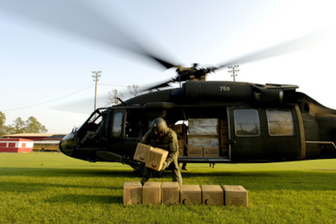 U.S. Army Sgt. Steven Giersch unloads meals, ready to eat from a UH-60A Black Hawk helicopter in Deweyville, Texas, on Sept. 26, 2005. Three Black Hawks delivered six pallets of relief aid during this mission. Department of Defense units are mobilized as part of Joint Task Force Rita to support the Federal Emergency Management Agency's disaster-relief efforts in the Gulf Coast areas devastated by Hurricane Rita. Giersch is assigned to A Company, 1st Battalion, 106th Aviation Regiment, Illinois Air National Guard. 