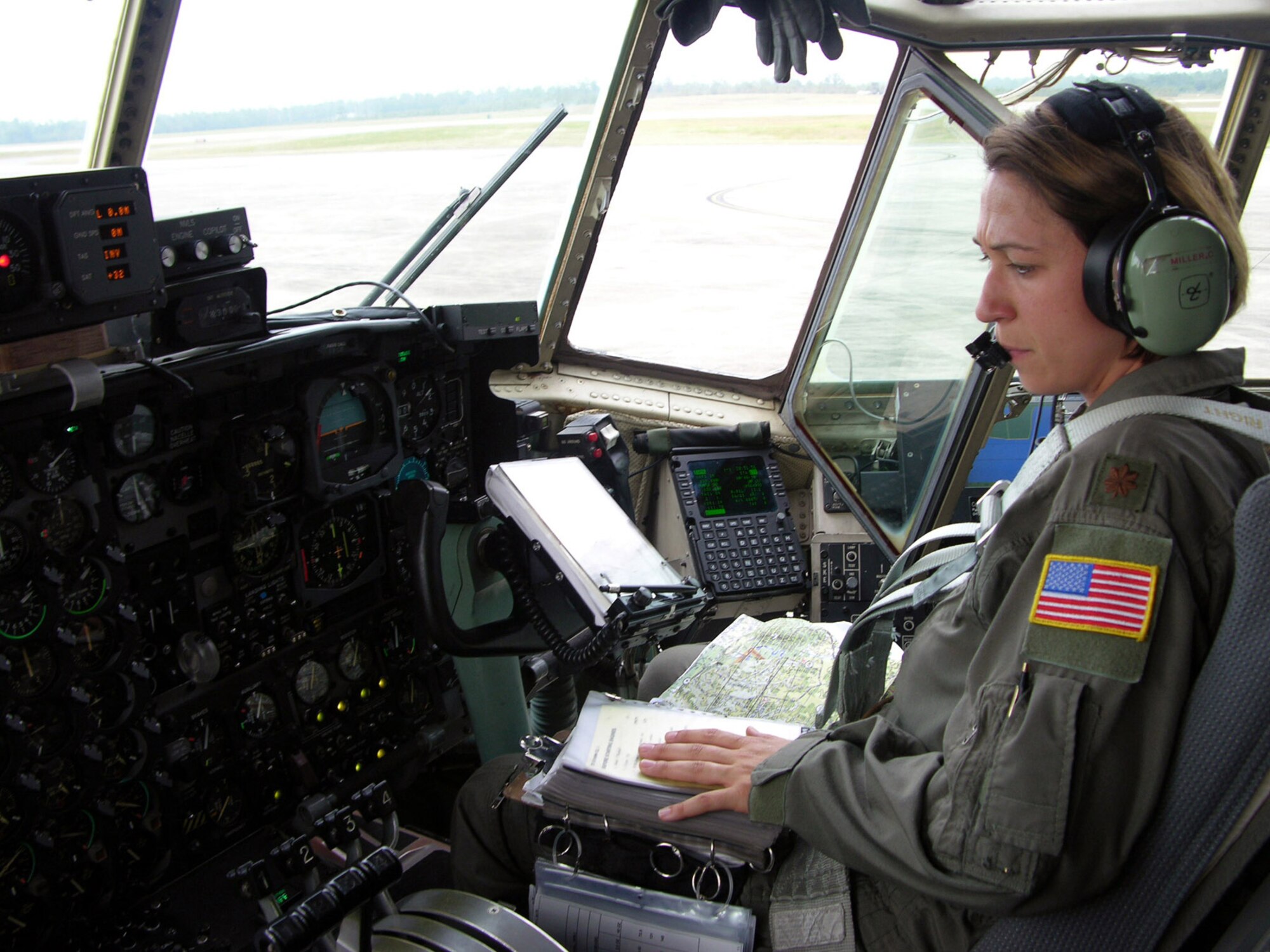 DUKE FIELD, Fla. -- Maj. Cathy Miller, co-pilot and aircraft commander for an aerial spray flight over Louisiana, goes through her preflight checklist shortly before takeoff. Air Force Reserve Command crews unanimously agree that the Gulf Coast missions are their most difficult aerial spray flights to date. (U.S. Air Force photo by Tech. Sgt. Shawn David McCowan)