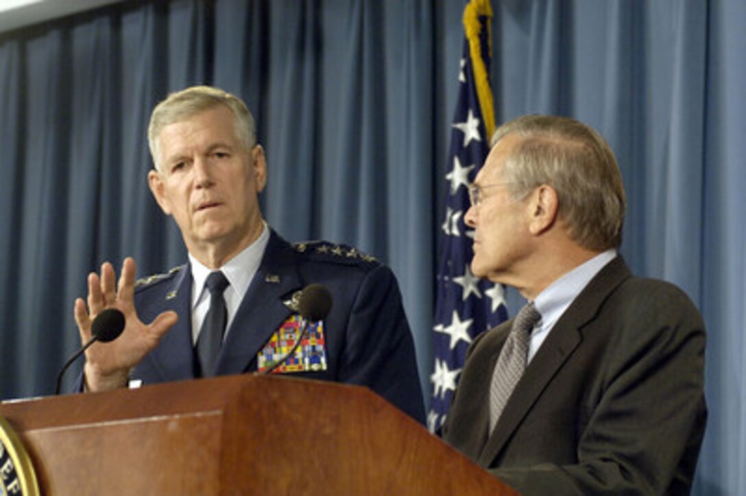 Secretary of Defense Donald H. Rumsfeld (right) looks on as Chairman of the Joint Chiefs of Staff Gen. Richard B. Myers, U.S. Air Force, responds to a reporter's question during a Pentagon press briefing on Sept. 27, 2005. Many of the questions raised by reporters concerned President Bush's suggestion that the armed forces be called upon to play a larger role in disaster response. 
