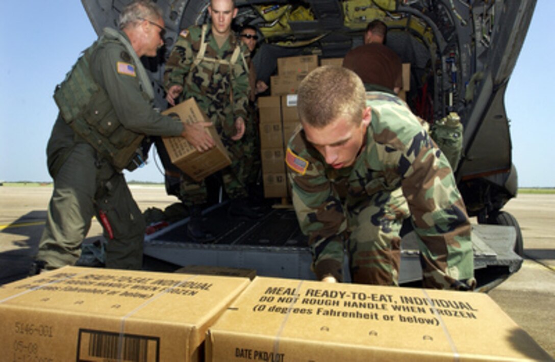 U.S. Army Pvt. Raef Hardin (right) and Spc. Jade Harris (second from left) help crew chief Staff Sgt. Brian Ogle (left) load hundreds of meals, ready to eat and water onto a CH-47 Chinook helicopter at Ellington Field, Texas, on Sept. 27, 2005. Department of Defense units are mobilized as part of Joint Task Force Rita to support the Federal Emergency Management Agency's disaster-relief efforts in the Gulf Coast areas devastated by Hurricane Rita. 