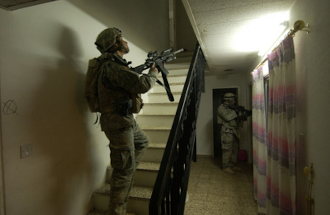 U.S. Army soldiers with Bravo Company, 2nd Battalion, 1st Infantry Division search a house in Anah, Iraq, on Sept. 28, 2005. 