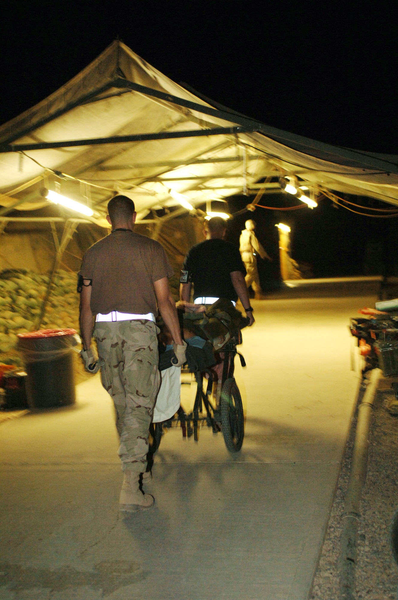 BALAD AIR BASE, Iraq -- Air Force medics rush an injured Iraqi from an ambulance here into the Air Force Theater Hospital on Sept. 29 after a suicide car bomb attack at the nearby town of Balad. (U.S. Air Force photo by Airman 1st Class Chad Watkins)