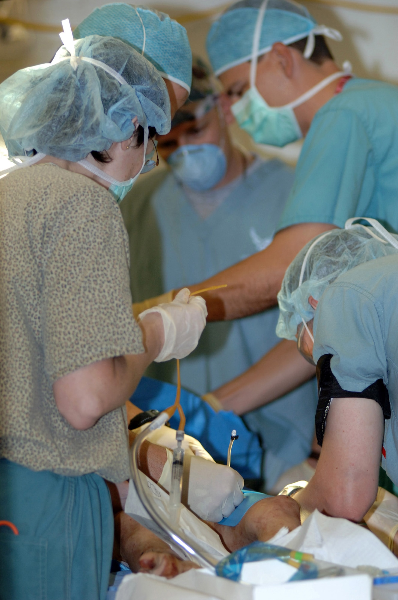 BALAD AIR BASE, Iraq -- Air Force surgeons operate on an Iraqi child who was caught in car bomb blasts that occurred in the town of Balad on Sept. 29. Injured Iraqis were rushed here to the Air Force Theater Hospital following the attack. (U.S. Air Force photo by Airman 1st Class Chad Watkins)