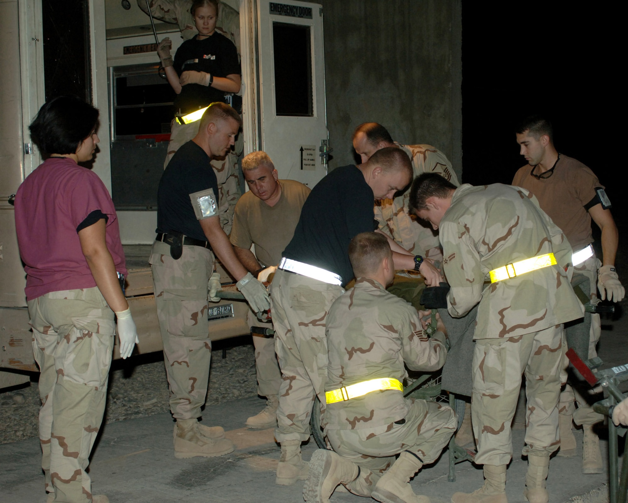 BALAD AIR BASE, Iraq -- Air Force medics rush an injured Iraqi from an ambulance Sept. 29 after being caught in car bomb blasts that occurred earlier that day in the town of Balad near here. Patients were rushed here to the Air Force Theater Hospital following the attack. (U.S. Air Force photo by Airman 1st Class Chad Watkins)