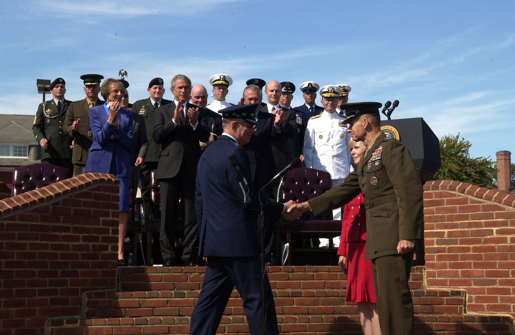 FORT MYER, Va. -- Gen. Richard B. Myers, 15th chairman of the Joint Chiefs of Staff, congratulates Marine Corps Gen. Peter Pace on becoming the 16th chairman of the Joint Chiefs of Staff here Sept. 30.  General Myers retired after 40 years of service, as General Pace became the 16th Chairman and first Marine to hold the nation's highest military position.  (U.S. Air Force photo by Tech. Sgt. Kevin Gruenwald)