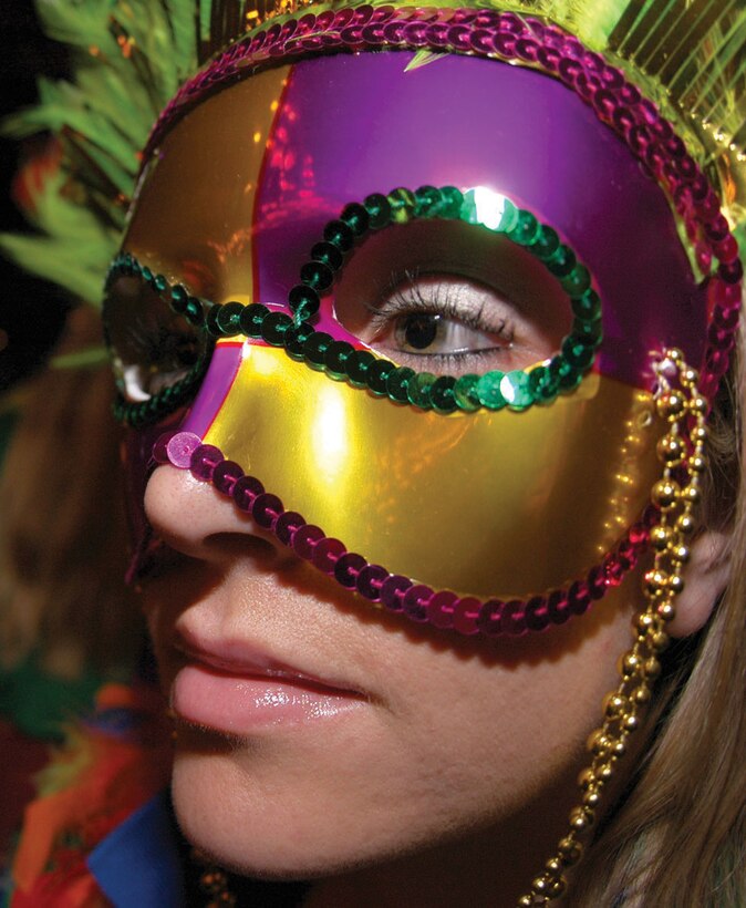 A mysteriously masked woman enjoys music from the Yuma Jazz Company in the Infinities enlisted club here Sept. 30 during the Marine Corps Community Services annual Mardi Gras party. The event, which raised money for active duty and retired service members and their families displaced by Hurricane Katrina, began in Infinites and later spread through the rest of the club.