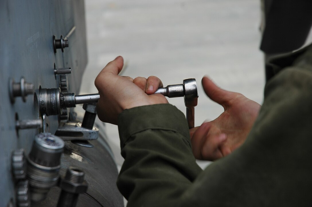Lance Cpl. Joshua M. Peterson tightens a bolt that holds a 500-pound, general-purpose bomb equipped with the Joint Direct Attack Munitions system, to the wing of an AV-8B Harrier April 3 at Al Asad, Iraq. Peterson is an ordnance technician for Marine Attack Squadron 513, Marine Aircraft Group 16, 3rd Marine Aircraft Wing a native of Indian Creek, Ill.
