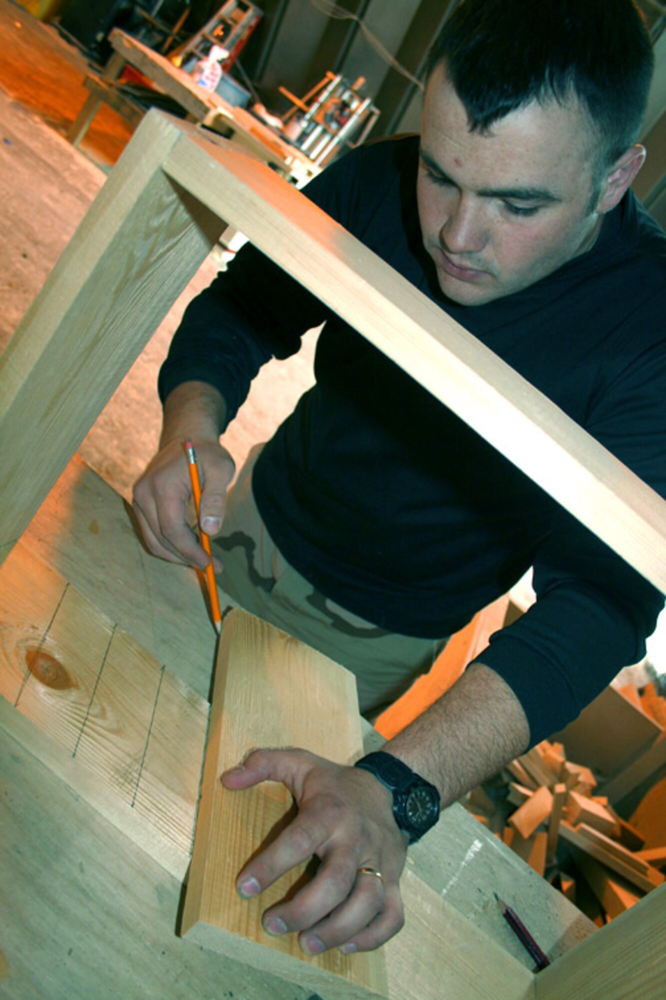 Senior Airman Jody Tolley constructs frames for ventilating the 376th Air Expeditionary Wing headquarters at Manas Air Base, Kyrgyzstan. The 376th Expeditionary Civil Engineer Squadron gutted the building in early February, rebuilt it and added a second level, increasing workspace by about 60 percent. The renovation is one of many projects under way to improve customer service capabilities and quality of life. Airman Tolley is a civil engineering structures specialist deployed from the 4th Civil Engineering Squadron at Seymour Johnson Air Force Base, N.C. (U.S. Air Force photo/Staff Sgt. Lara Gale)


