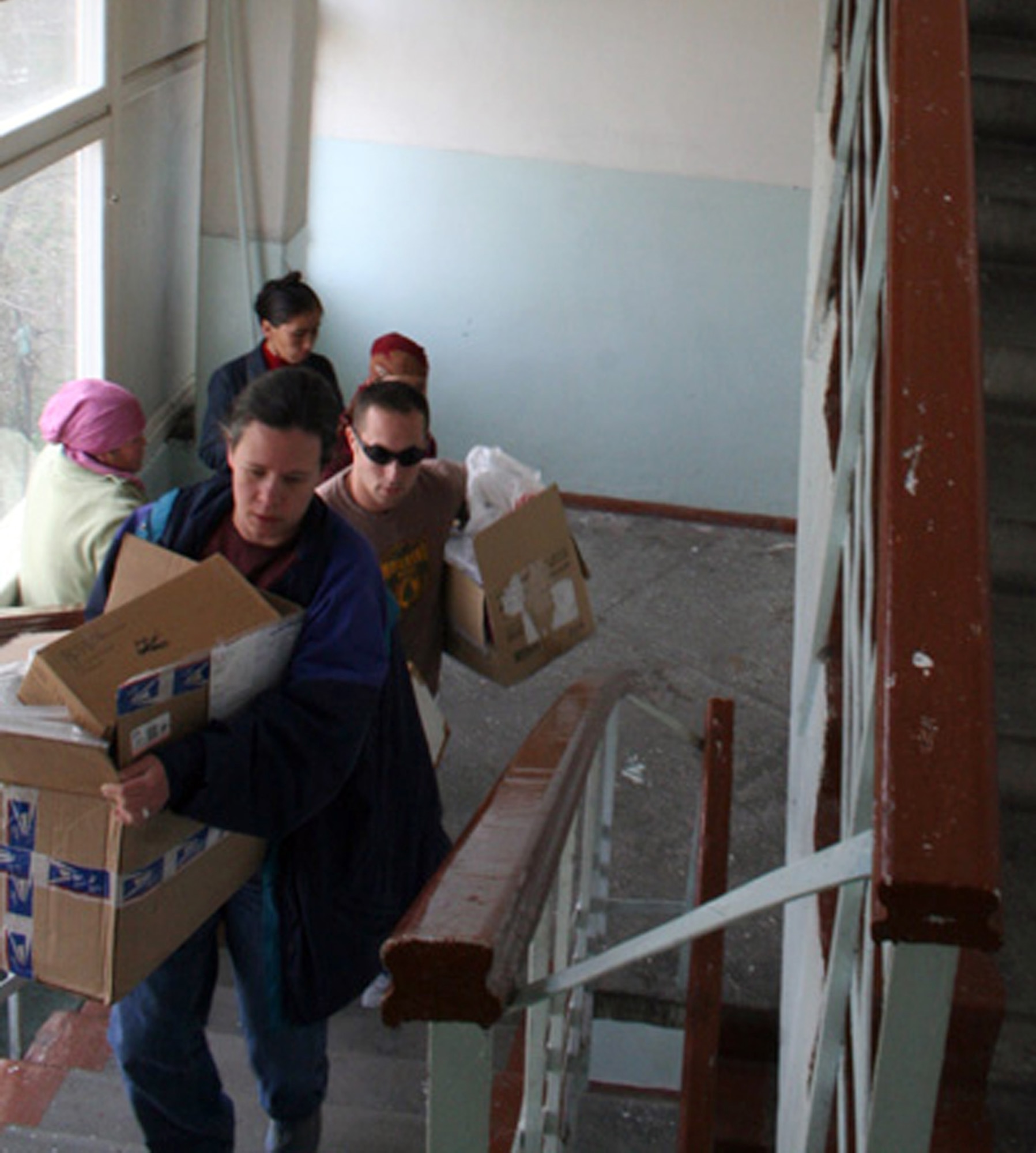 Airmen carry boxes of donated medical supplies, linens, treats and toys to a burn ward on the third floor of the Bishkek Trauma Center in Kyrgyzstan. Working with the Manas Air Base Outreach Society, an all-volunteer organization, Maj. (Dr.) Stephania Timothy and others on her surgical team are helping develop a rehabilitation program for the ward to help improve patients' recovery. The surgical team is deployed to the 376th Medical Group from the 10th Medical Operations Squadron at the Air Force Academy in Colorado. (U.S. Air Force photo/Staff Sgt. Lara Gale)

