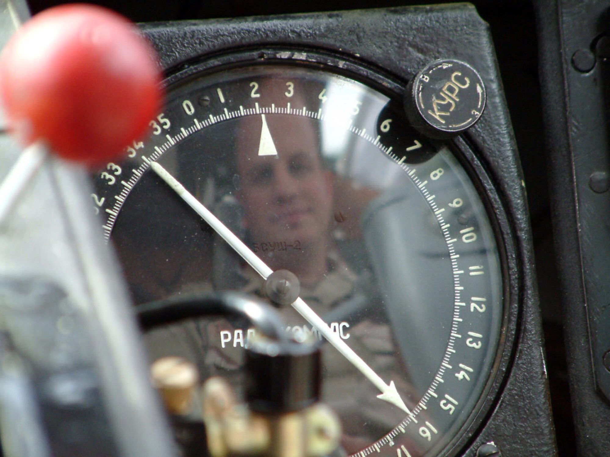 Capt. James Peterson is reflected in the control panel of an AN-2 biplane during the first U. S. military tour of Kyrgyzstan's Frunze Air Base no.1. Captain Peterson is one of 16 base members invited to tour the Kyrgyz installation helping to promote better relations and enhance cooperation between U.S. Airmen and their Kyrgyz counterparts. Captain Peterson is a linguist with the 376th Air Expeditionary Wing. (U.S. Air Force photo/Capt. James Bressendorff) 