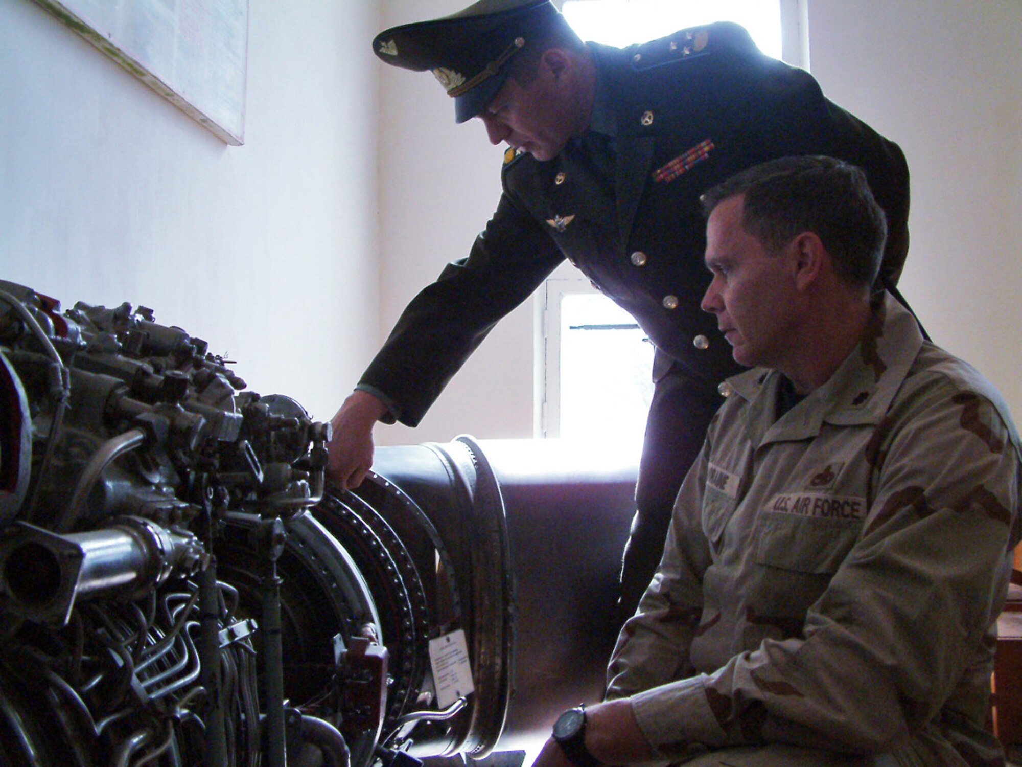 Kyrgyz Air Force Col. Sergey Slomatov shows Lt. Col. Eric Lorraine the internal mechanics of a Soviet built MI-24 Hind helicopter engine in one of Frunze Air Base No. 1's classrooms. Colonel Lorraine is commander of the 376th Expeditionary Maintenance Group. (U.S. Air Force photo/Capt. James Bressendorff) 