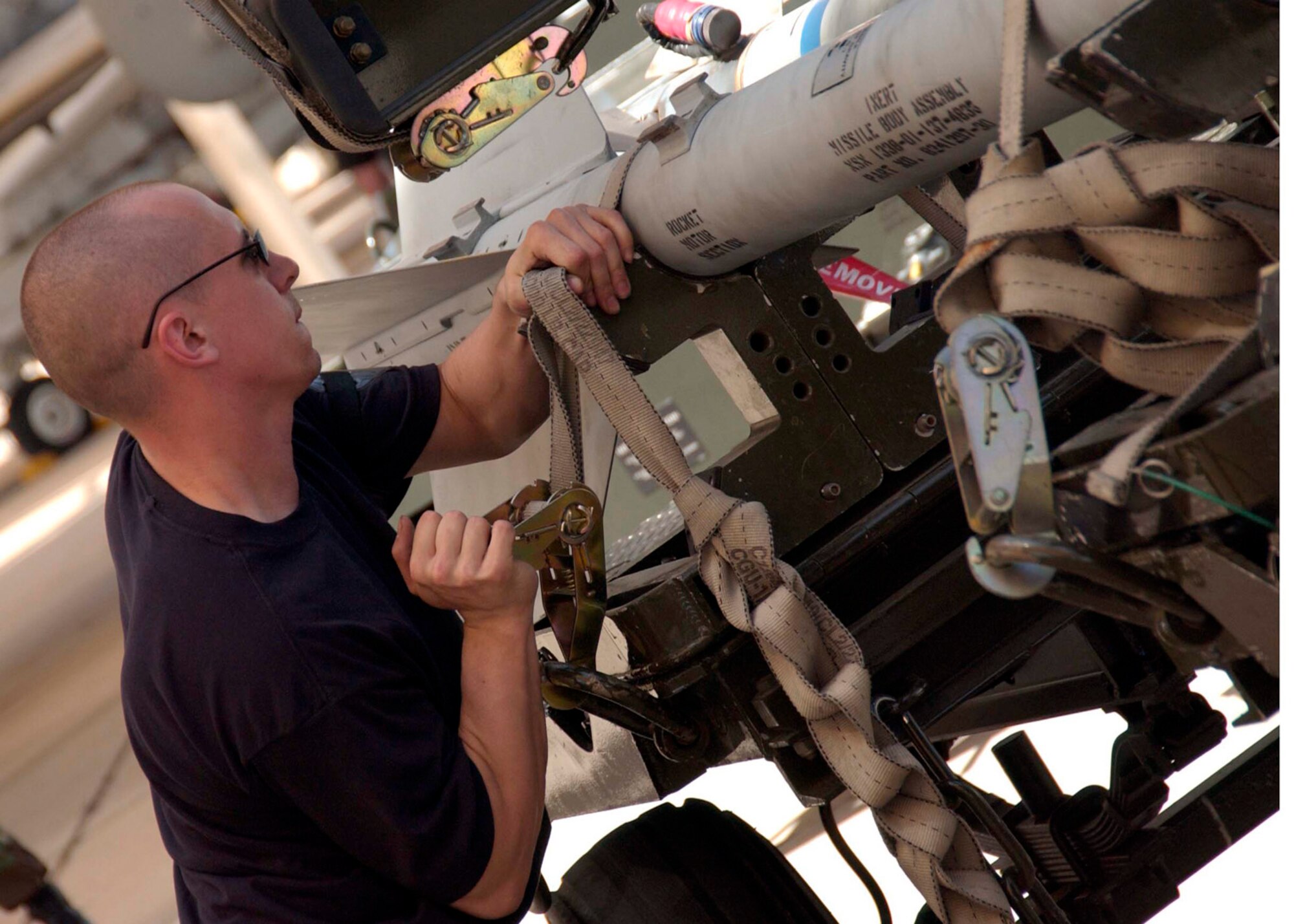 An Airman from the 355th Aircraft Maintenance Squadron secures an AIM-9 during Exercise Bushwacker 06-02, on Friday, March 31, 2006, at Davis-Monthan Air Force Base, Ariz.  The operational readiness exercise helps ensure Airmen are ready to deploy. (U.S. Air Force photo/Airman Alesia Goosic)