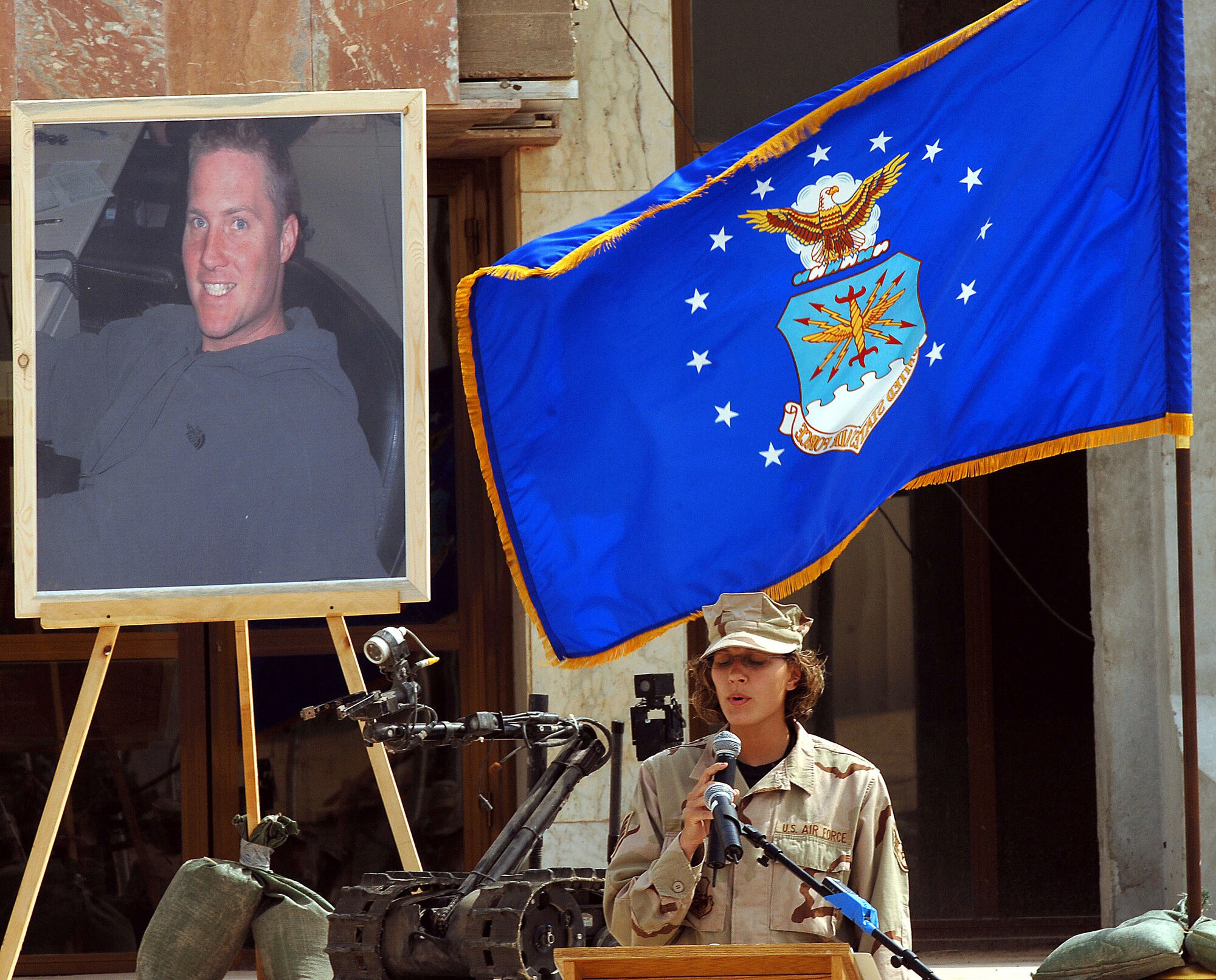 Staff Sgt. Sevina Watson sings "It is well within my soul" at a memorial service for Tech. Sgt. Walter Moss on Saturday, April 1, 2006, at Sather Air Base, Iraq. Sergeant Moss, a 447th Expeditionary Civil Engineer Squadron explosive ordnance disposal flight technician, died in an explosion during safing operations near Baghdad March 29. Sergeant Moss was the first Airman from Sather AB killed in action during Operation Iraqi Freedom. (U.S. Air Force photo/Master Sgt. Will Ackerman)