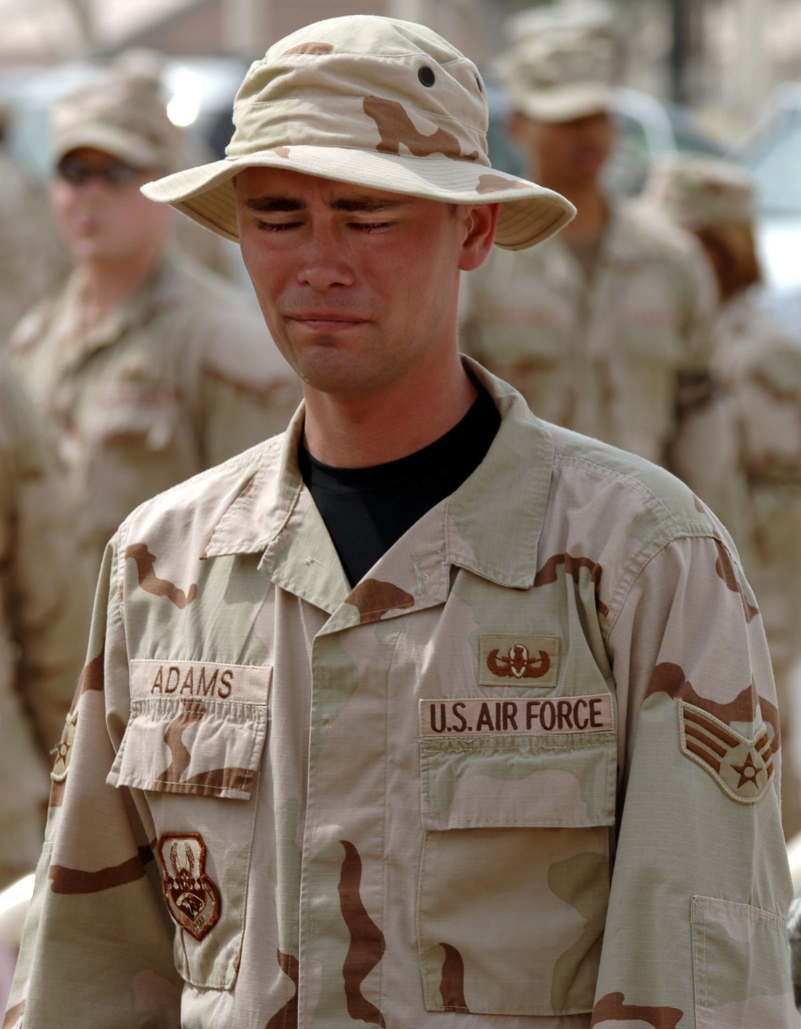 Senior Airman James Adams mourns at a memorial service for his supervisor, Tech. Sgt. Walter Moss, on Saturday, April 1, 2006, at Sather Air Base, Iraq. Sergeant Moss, a 447th Expeditionary Civil Engineer Squadron explosive ordnance disposal flight technican, died in an explosion during safing operations near Baghdad March 29. Sergeant Moss was the first Airman from Sather AB killed in action during Operation Iraqi Freedom. (U.S. Air Force photo/Master Sgt. Will Ackerman)