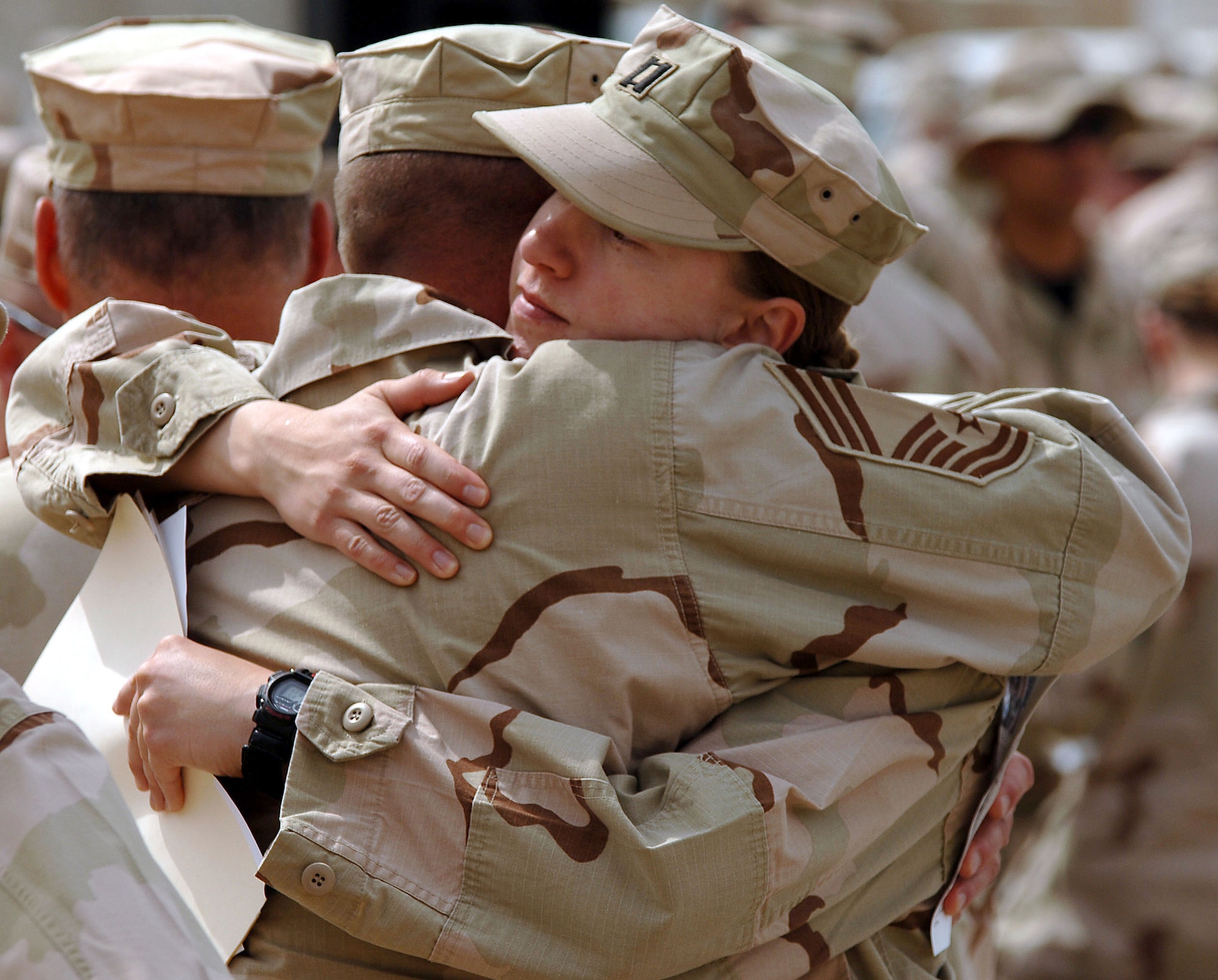 A chief master sergeant consoles Capt. Stephanie Root after a memorial service for Tech. Sgt. Walter Moss on Saturday, April 1, 2006, at Sather Air Base, Iraq. Sergeant Moss, an explosive ordnance disposal technician, died in an explosion during safing operations near Baghdad March 29. Captain Root was Sergeant Moss' 447th Expeditionary Civil Engineer Squadron EOD flight commander. Sergeant Moss was the first Airman from Sather AB killed in action during Operation Iraqi Freedom. (U.S. Air Force photo/Master Sgt. Will Ackerman)