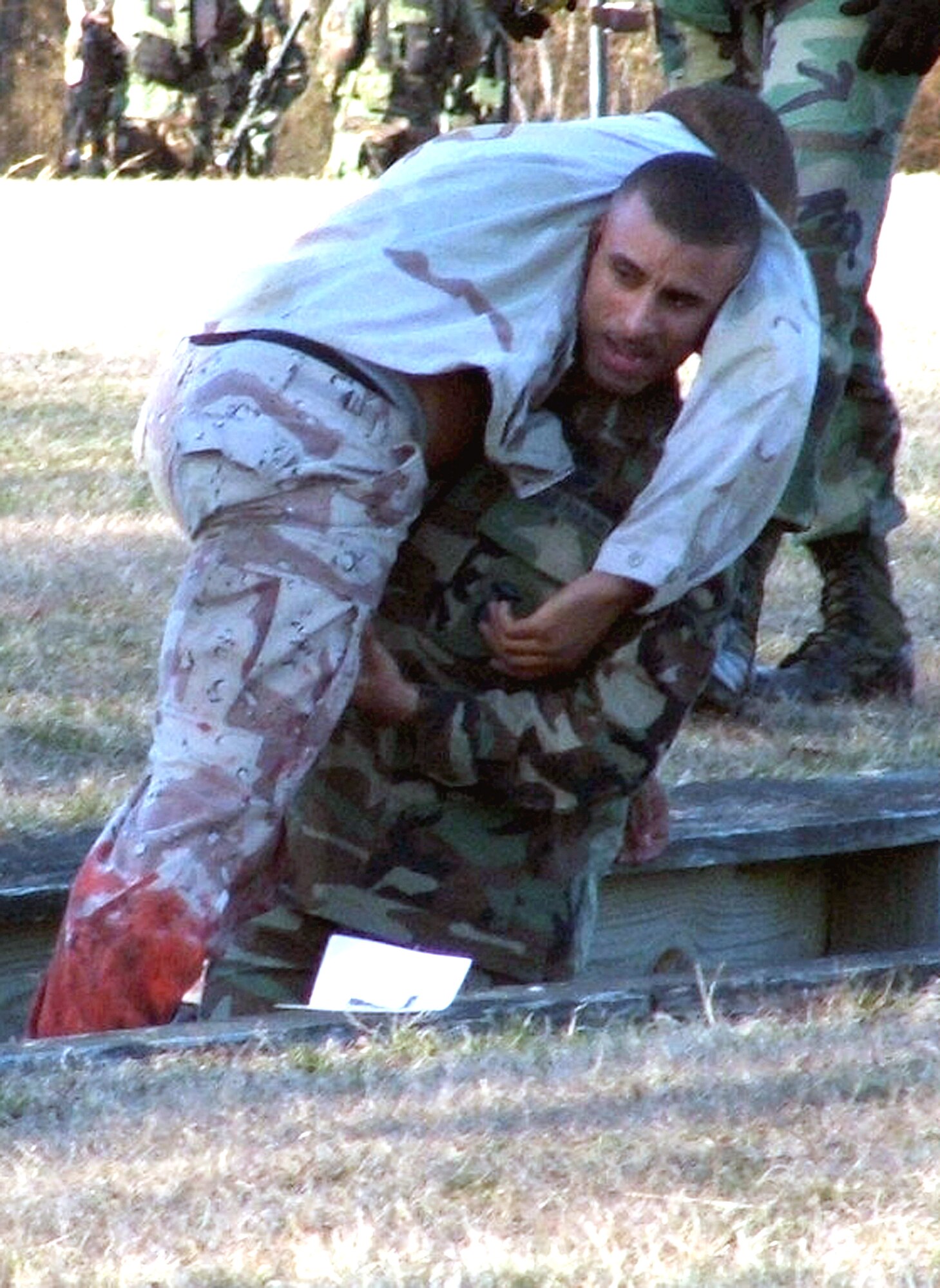 Airman 1st Class Randell Rosado carries a simulated "patient" through an obstacle course during combat first aid training at Air Force Phoenix Raven Course 06-D on Monday, March 27, 2006, at Fort Dix, N.J.  The course is taught by the Air Mobiltiy Warfare Center's 421st Combat Training Squadron.  Airman Rosado is with the 816th Global Mobility Readiness Squadron at McGuire Air Force Base, N.J. (U.S. Air Force photo/Tech. Sgt. Scott T. Sturkol)