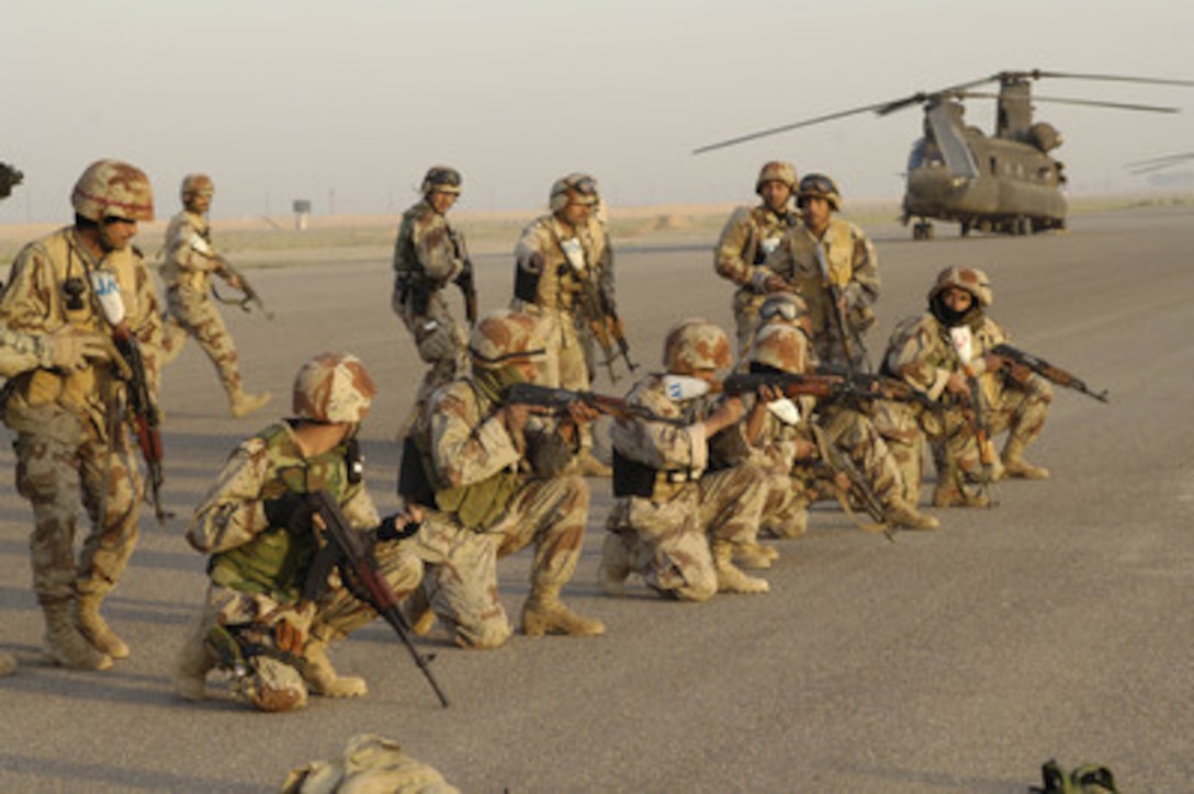 Iraqi army soldiers rehearse the initial movement from a U.S. Army CH-47 Chinook helicopter prior to lift-off for an air assault operation from Forward Operating Base Remagen, Iraq, on March 31, 2006. The soldiers are from the Iraqi armys1st Battalion, 1st Brigade, 4th Division. 